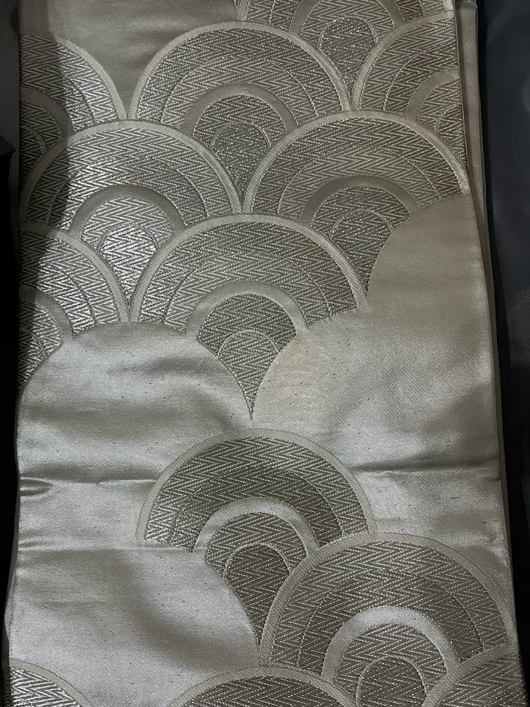 Silk scarf with geometric pattern on a plain background