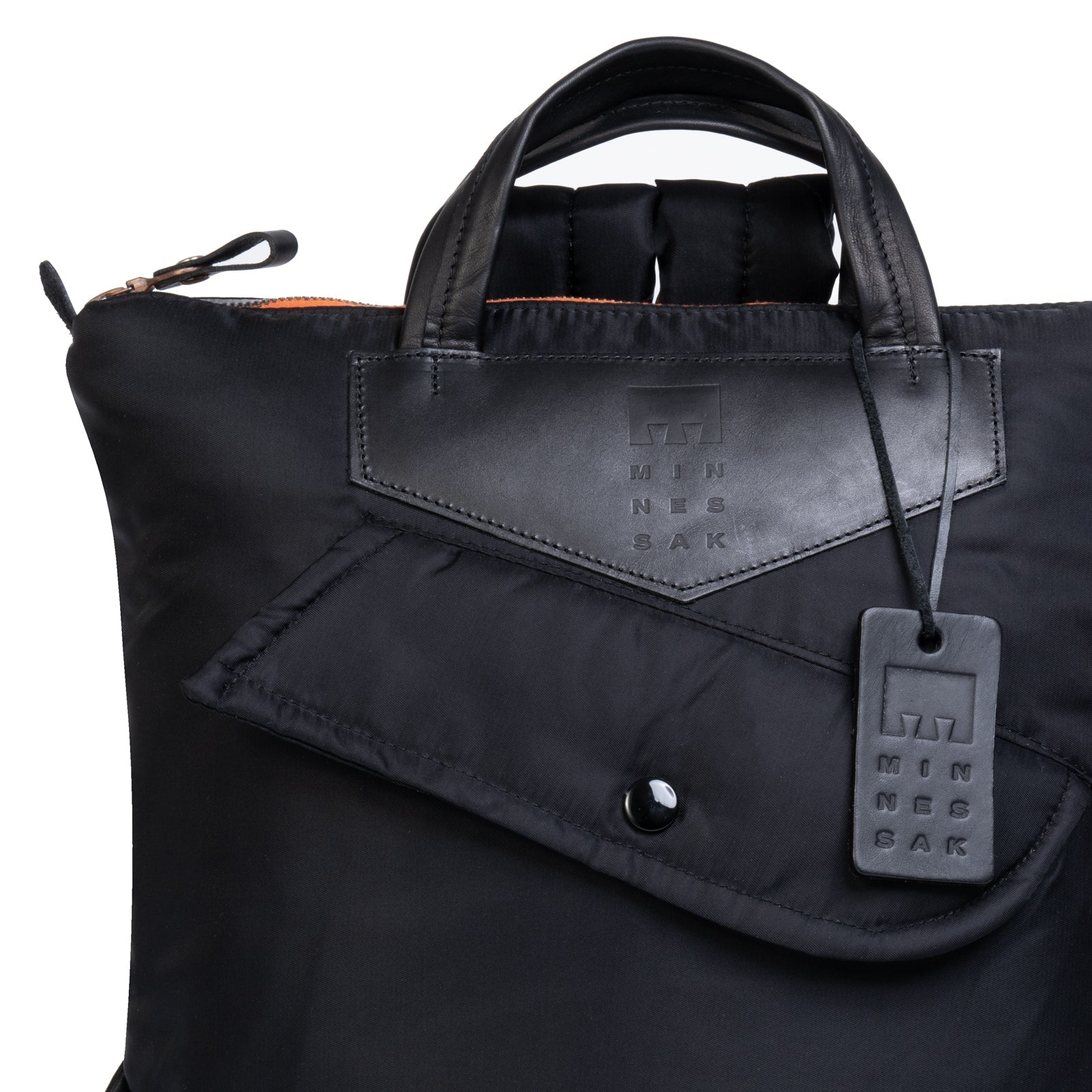 Black bag with a visible brand tag on a white background