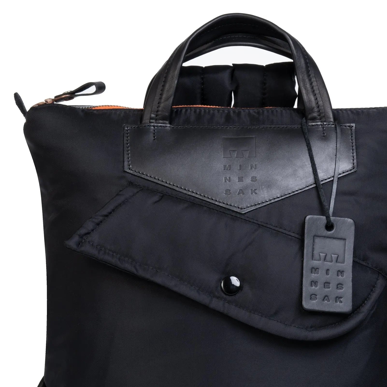 Black bag with a visible brand tag on a white background