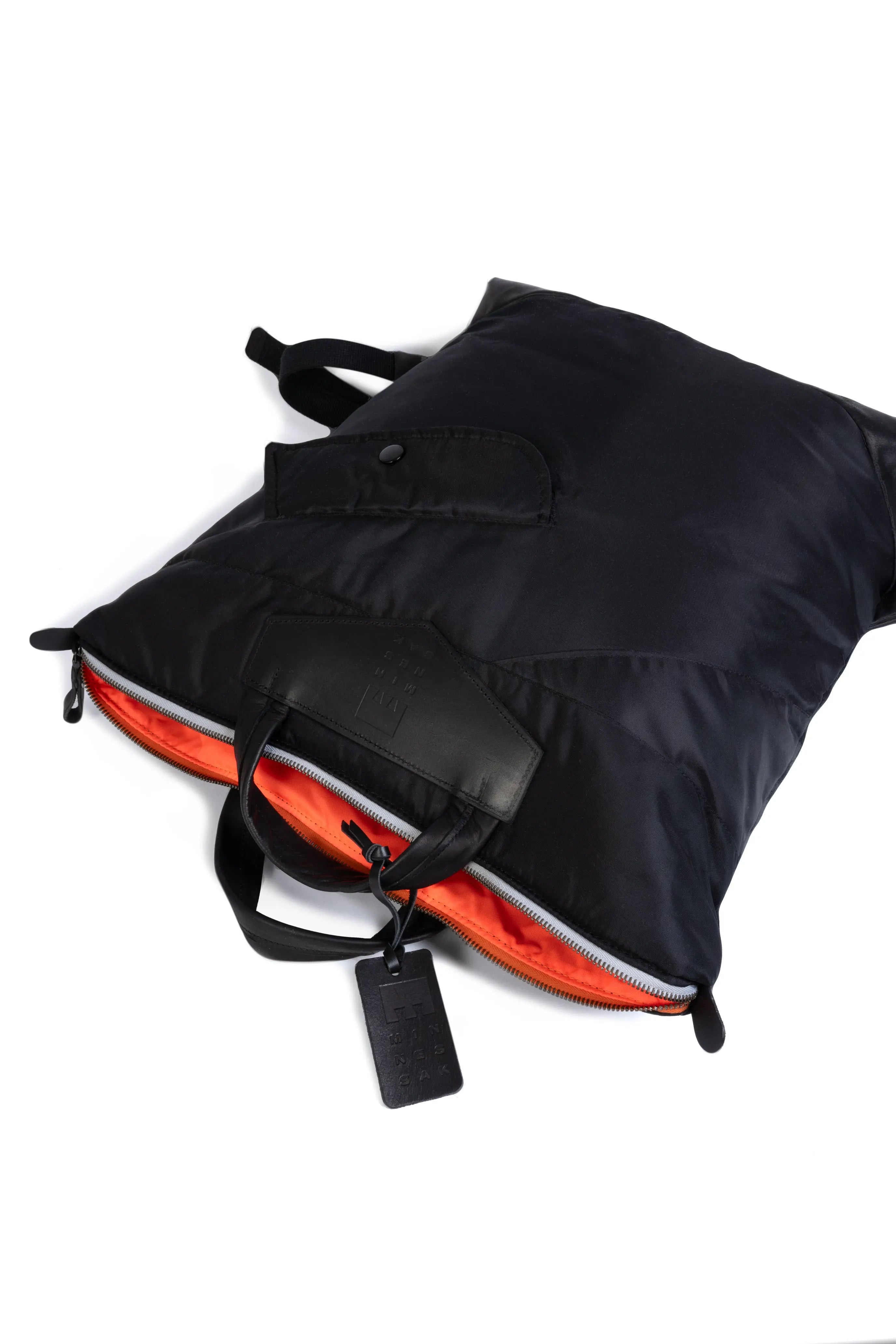 Black and orange backpack on a white background