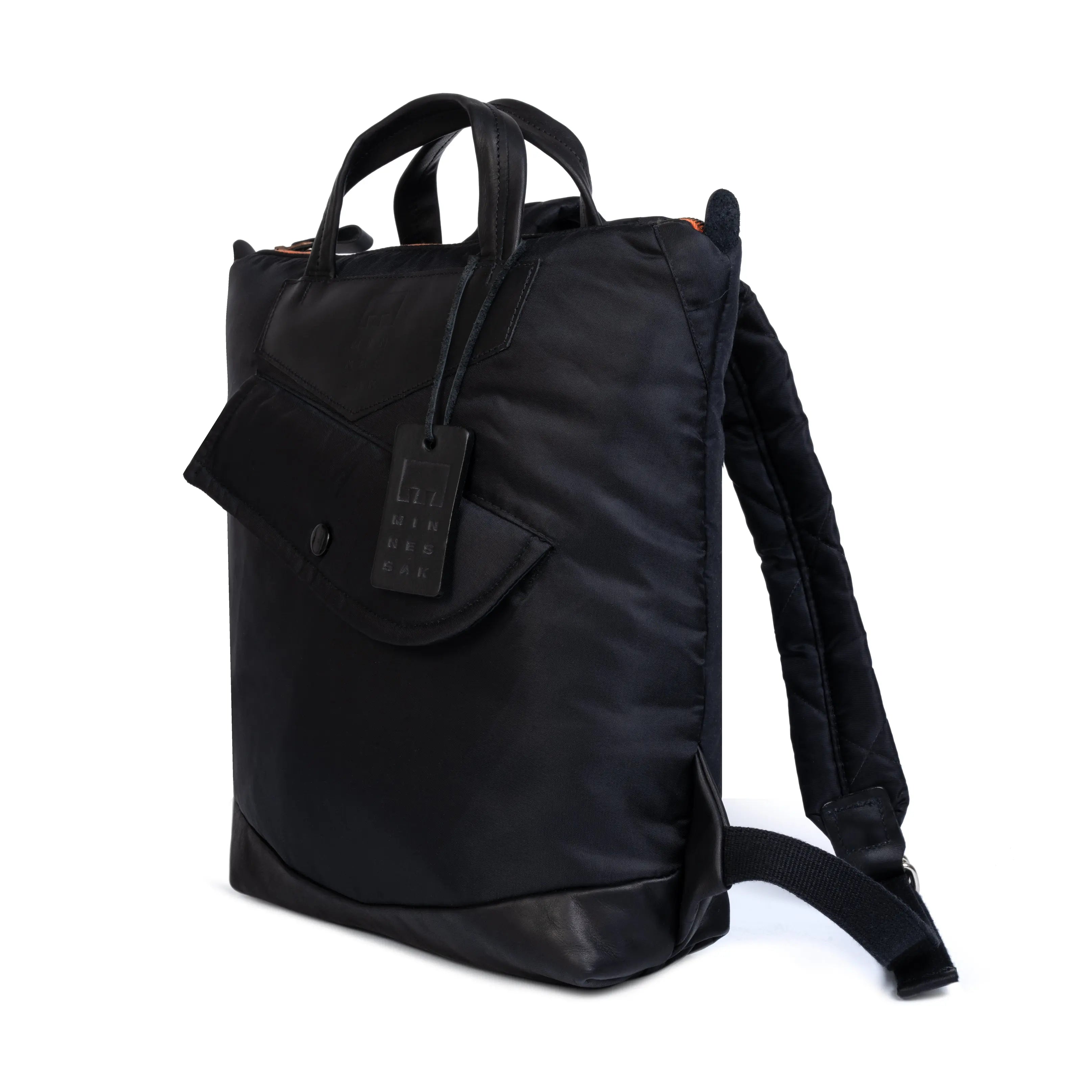 Black backpack with a tag on a white background