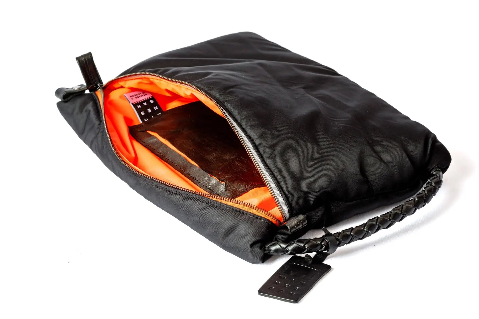 Black travel bag with orange interior on a white background