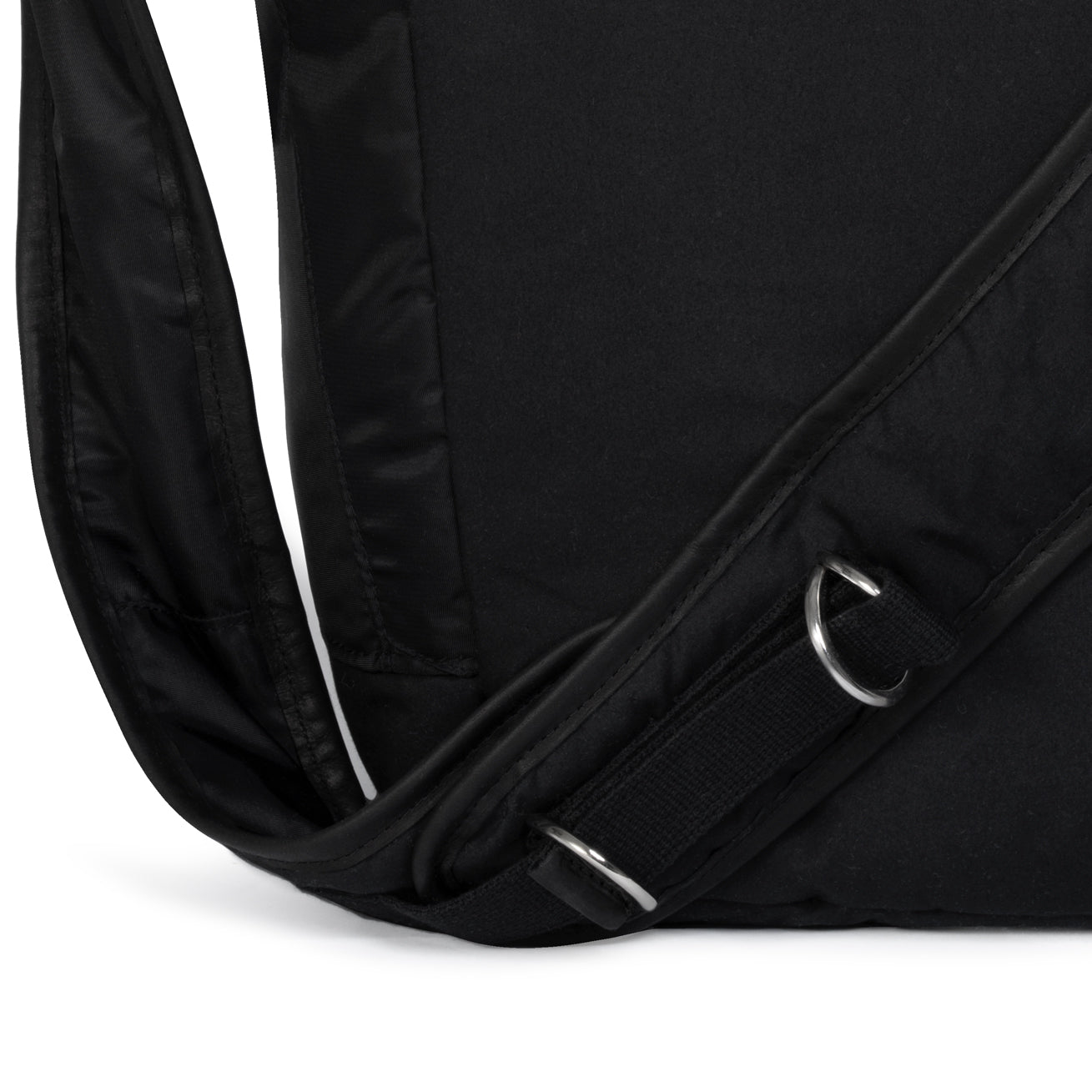 Close-up of a black bag strap with a metal buckle on a white background