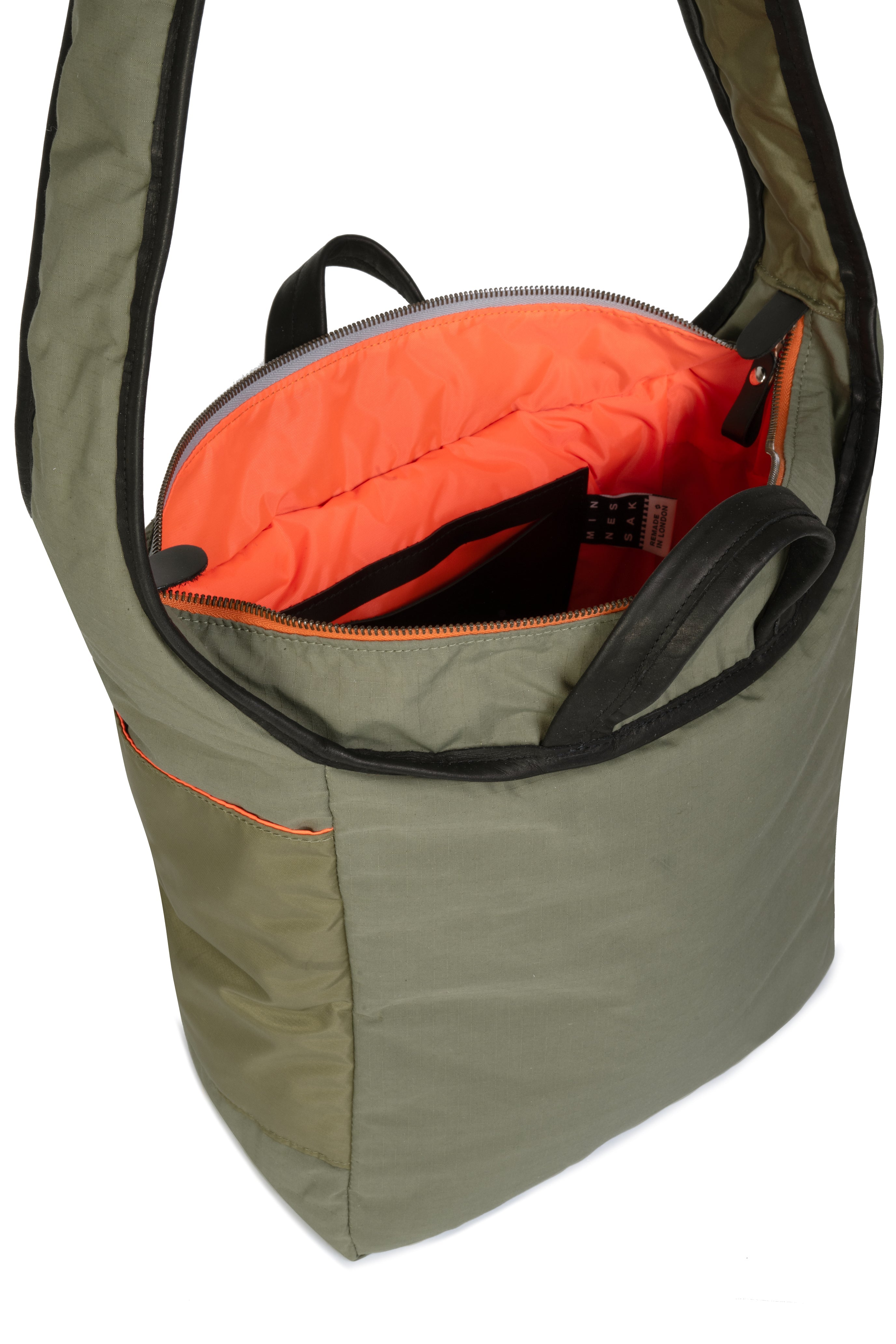 Olive bag with orange interior on a white background