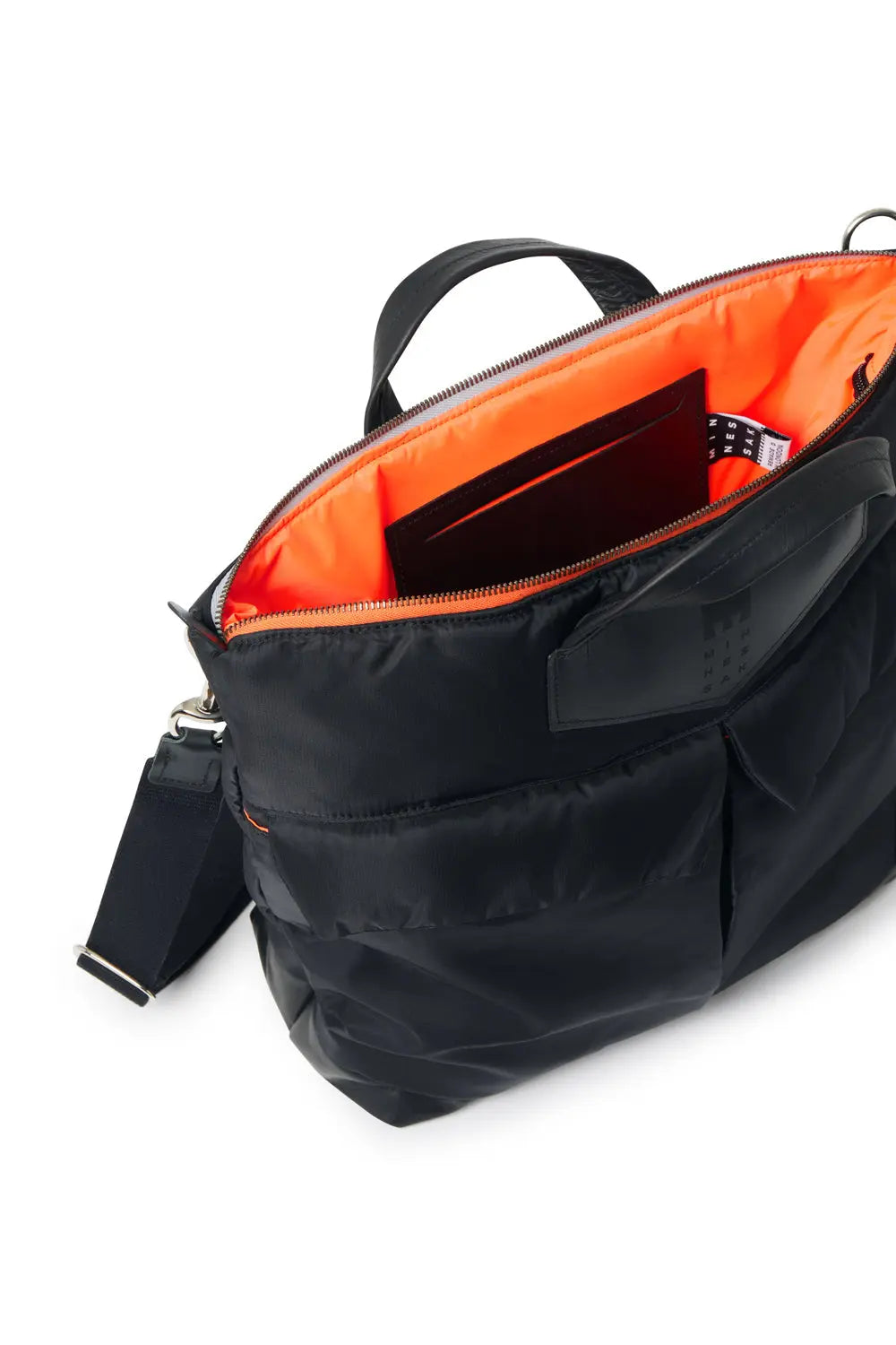 Black bag with orange interior on a white background