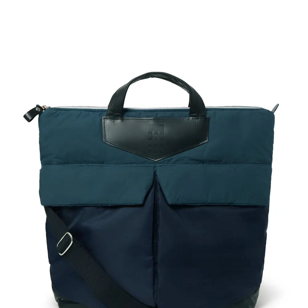 Navy backpack with a leather patch on a white background