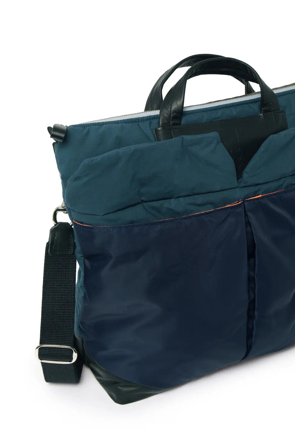 Navy blue bag with a shoulder strap on a white background