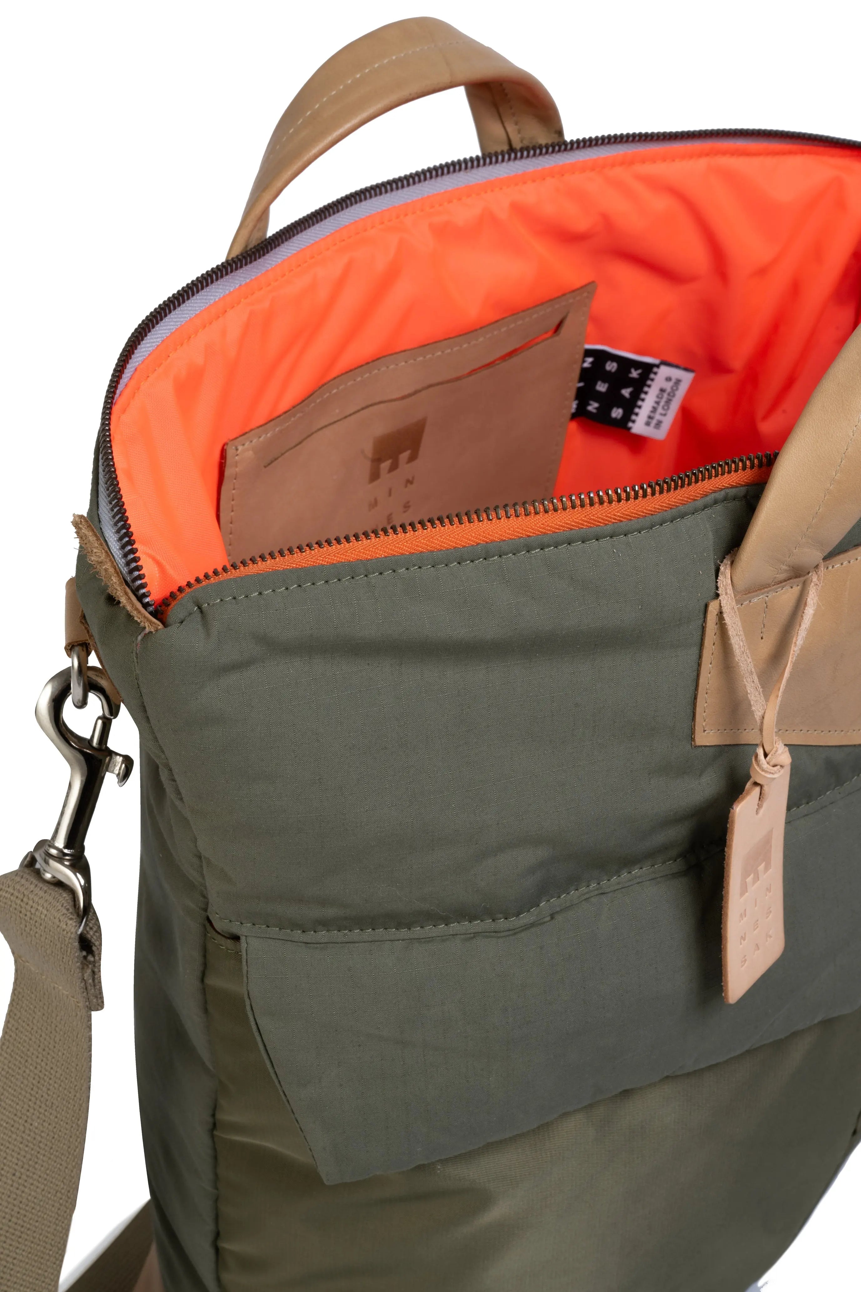 Olive backpack with orange interior and visible brand logo on a white background