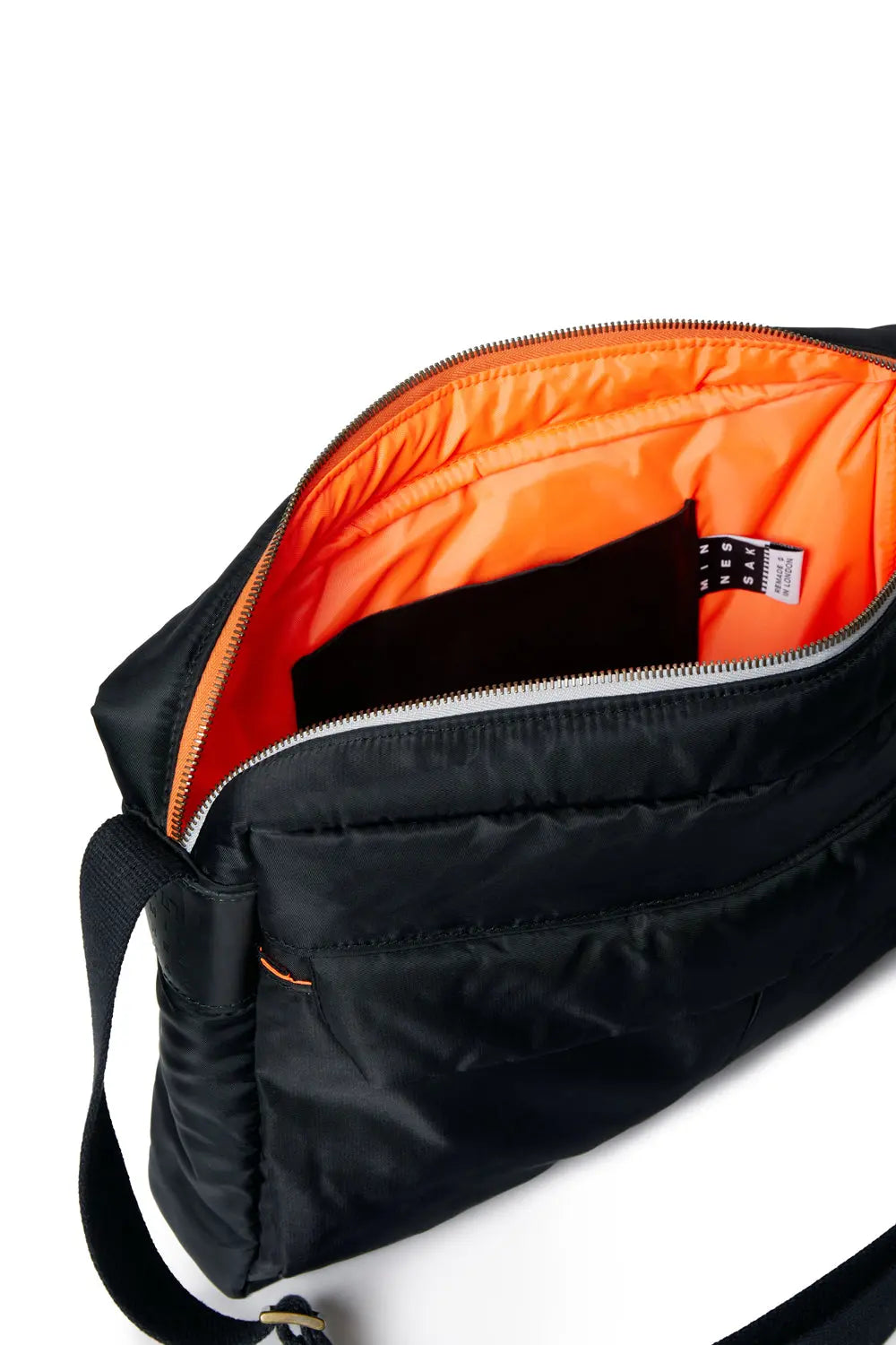 Black bag with orange interior on a white background