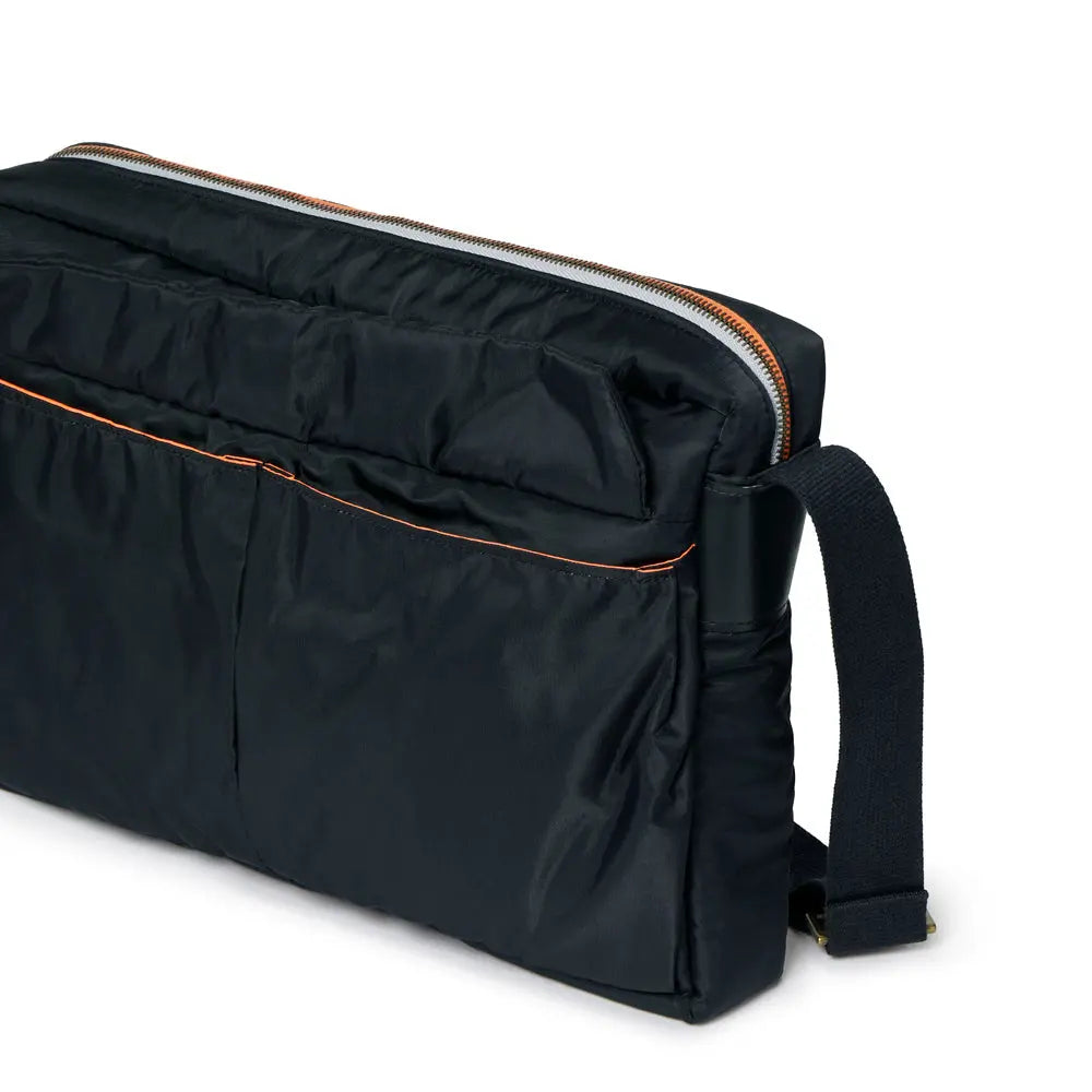 Black bag with orange zipper on a white background