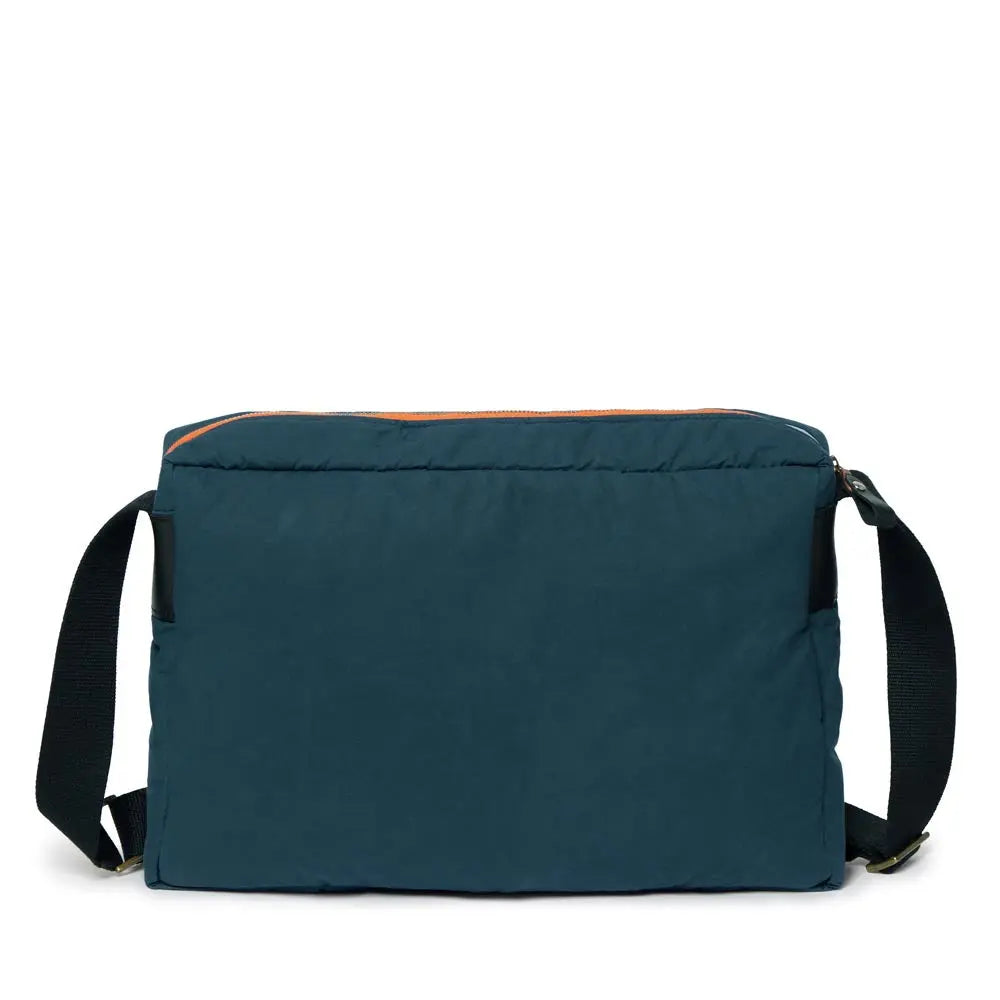 Blue messenger bag with black straps on a white background