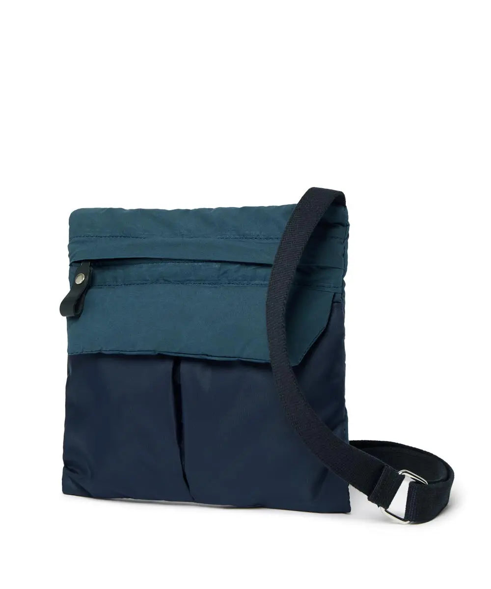 Two-toned blue bag with a black strap on a white background
