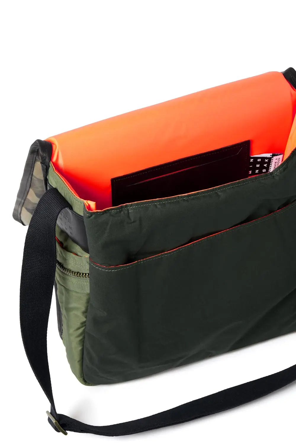 Olive and orange bag with a black strap on a white background