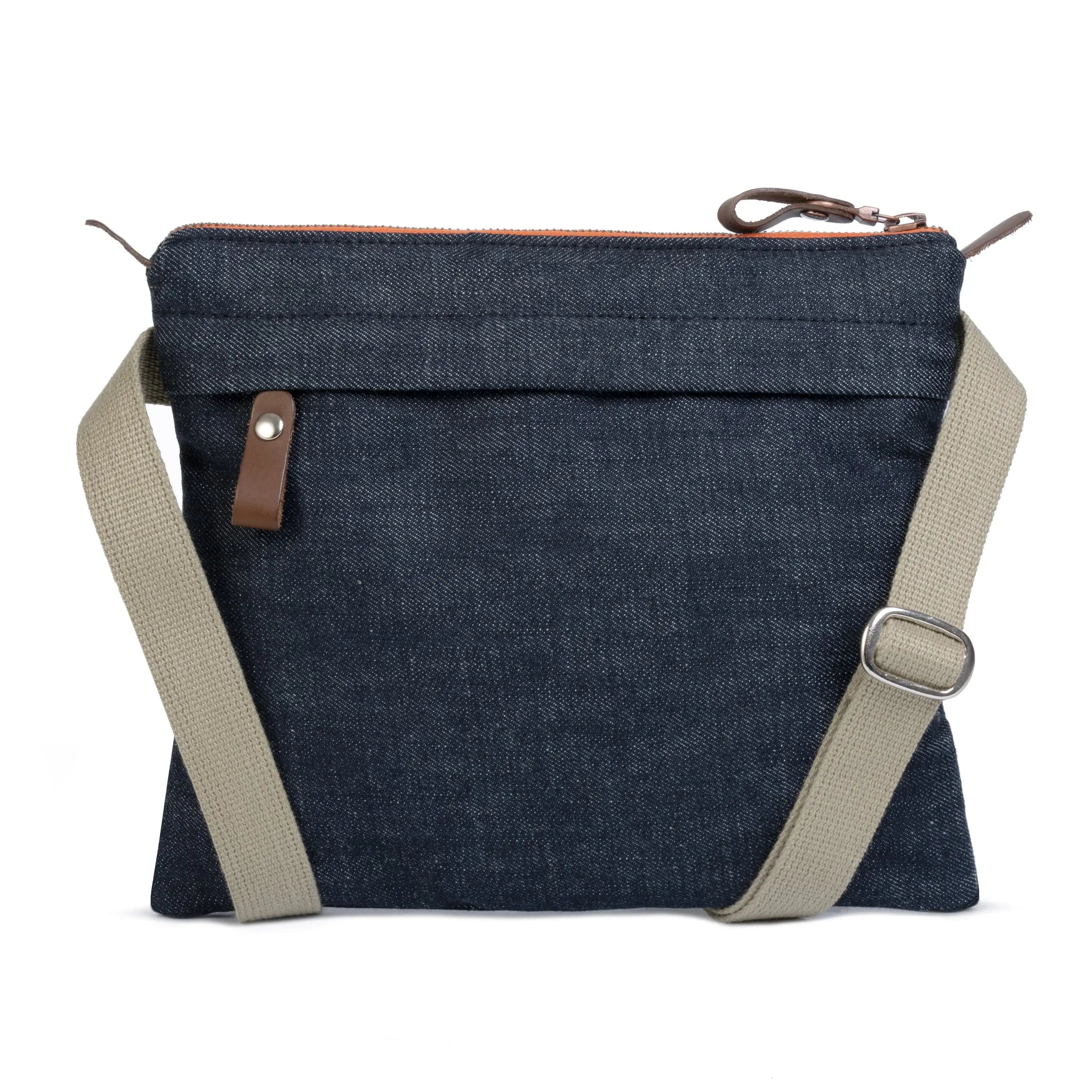 Blue denim crossbody bag with beige strap on a white background