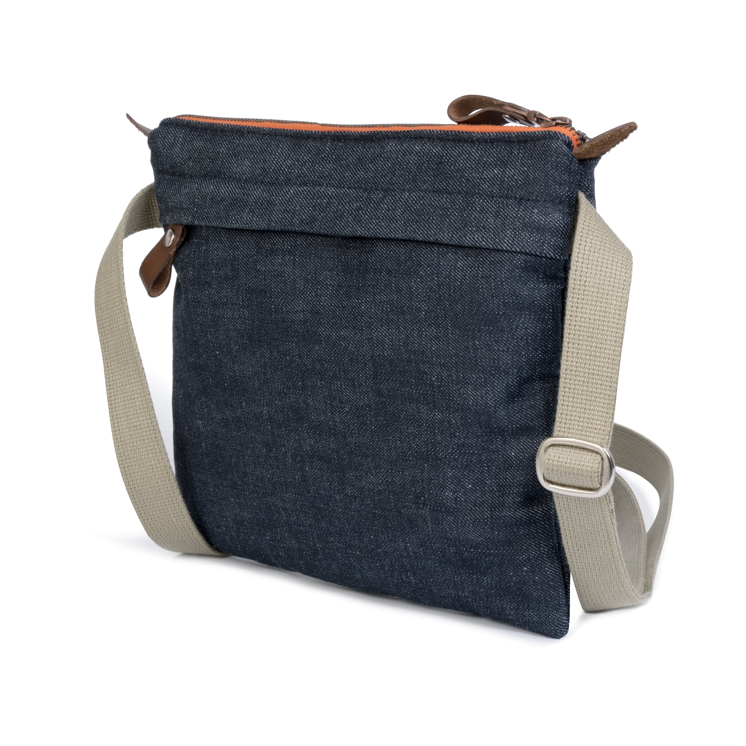 Blue denim crossbody bag with beige strap on a white background