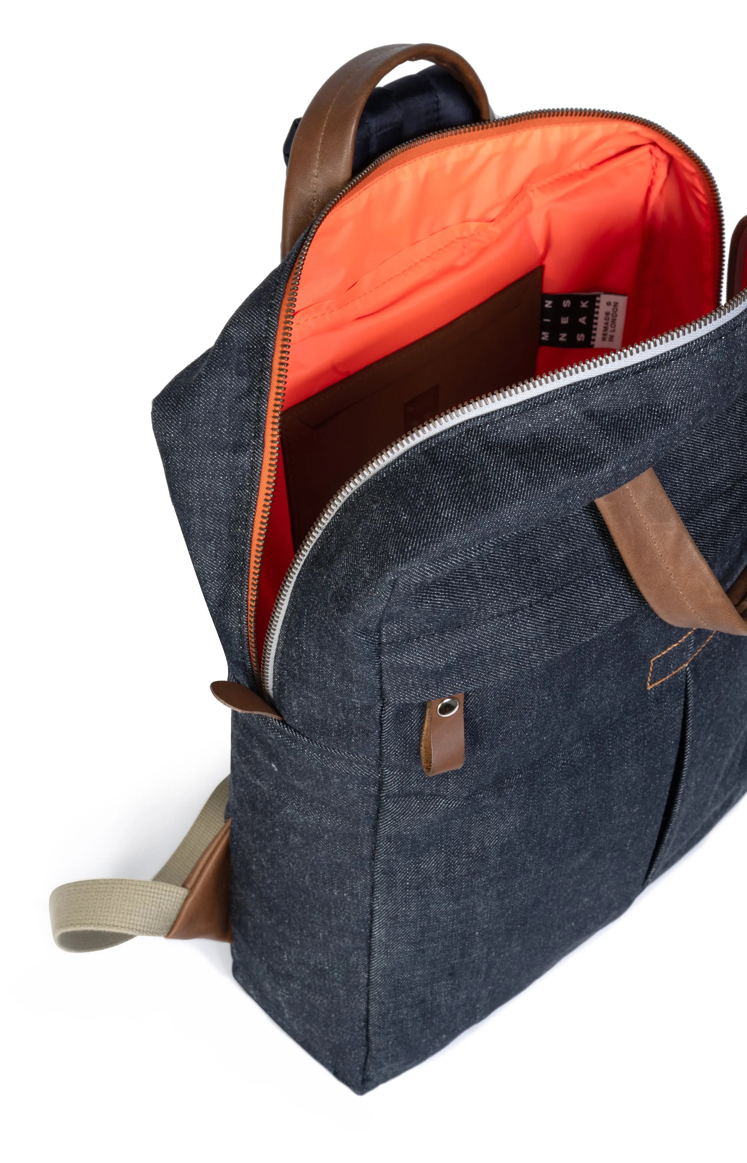 Blue denim backpack with orange interior on a white background