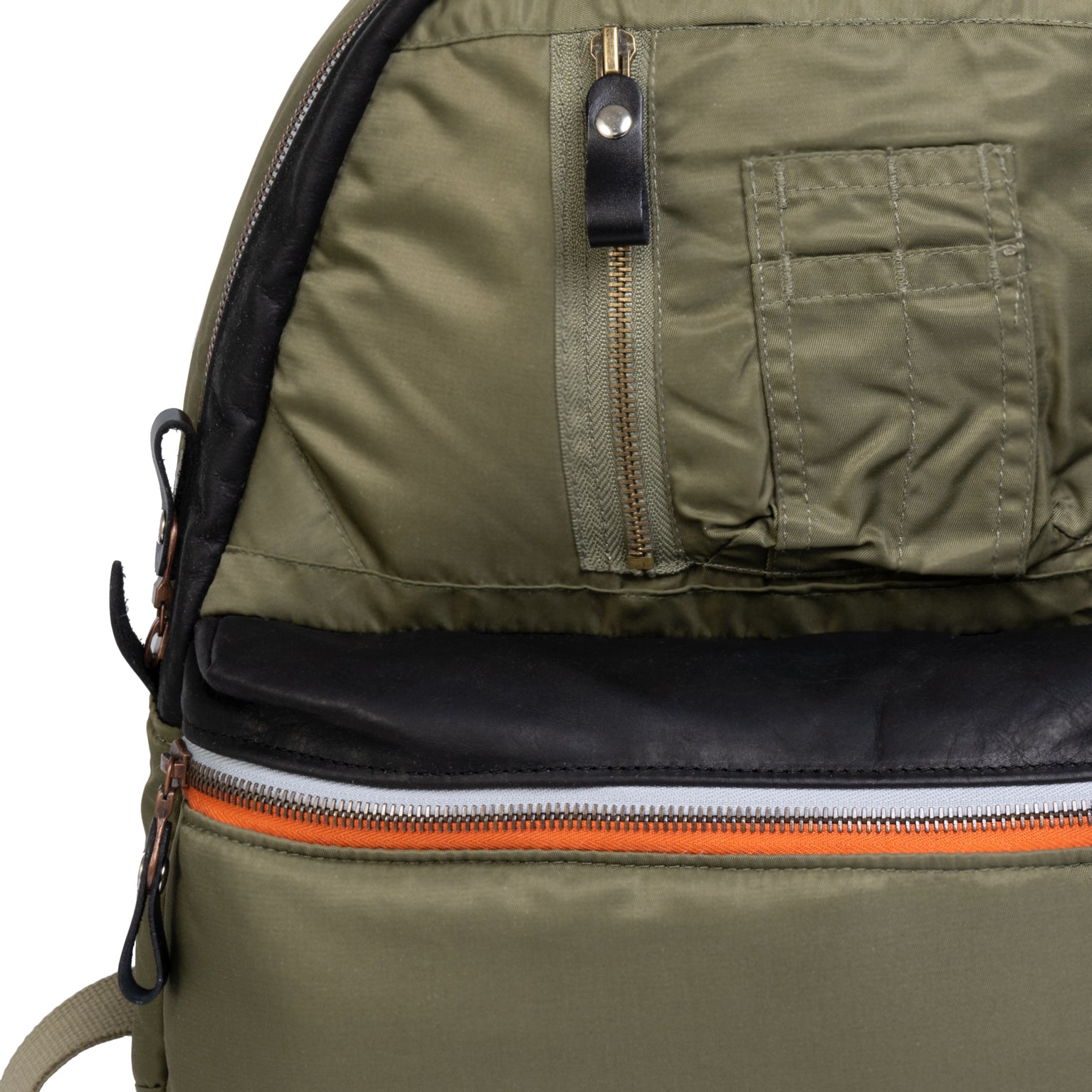 Close-up of a Olive backpack with zippers and a pocket.
