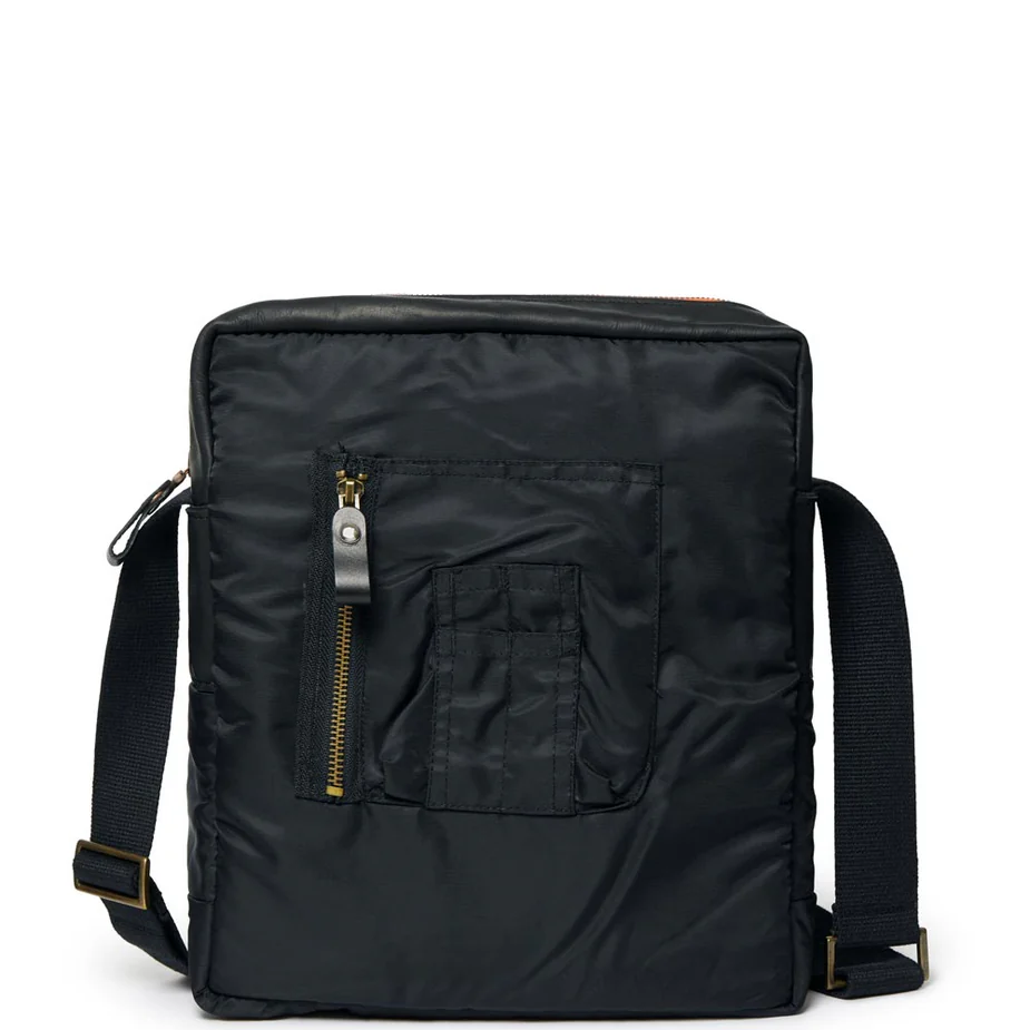 Black backpack with a strap and a front pocket and zipper on a white background