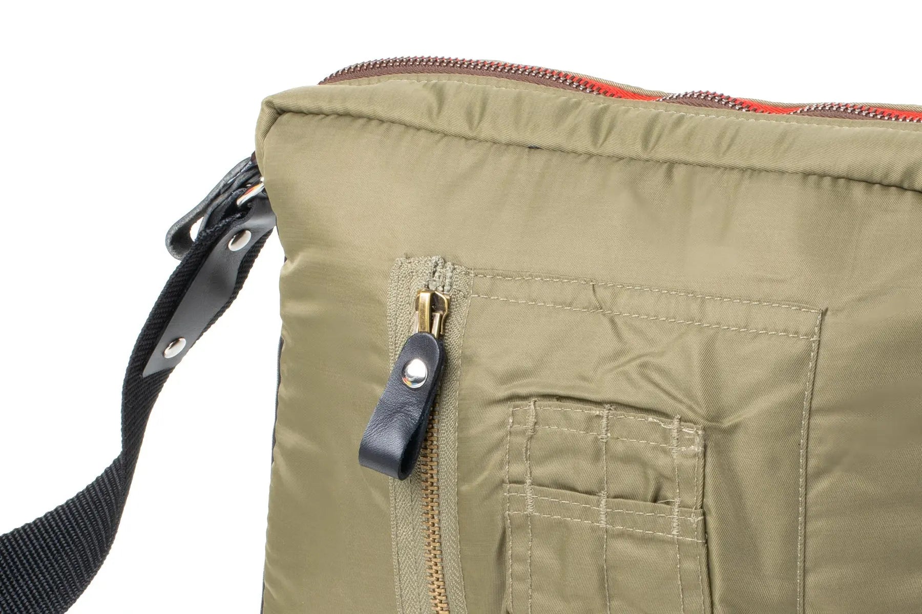 Close-up of an Olive bag with a strap and zipper detail on a white background