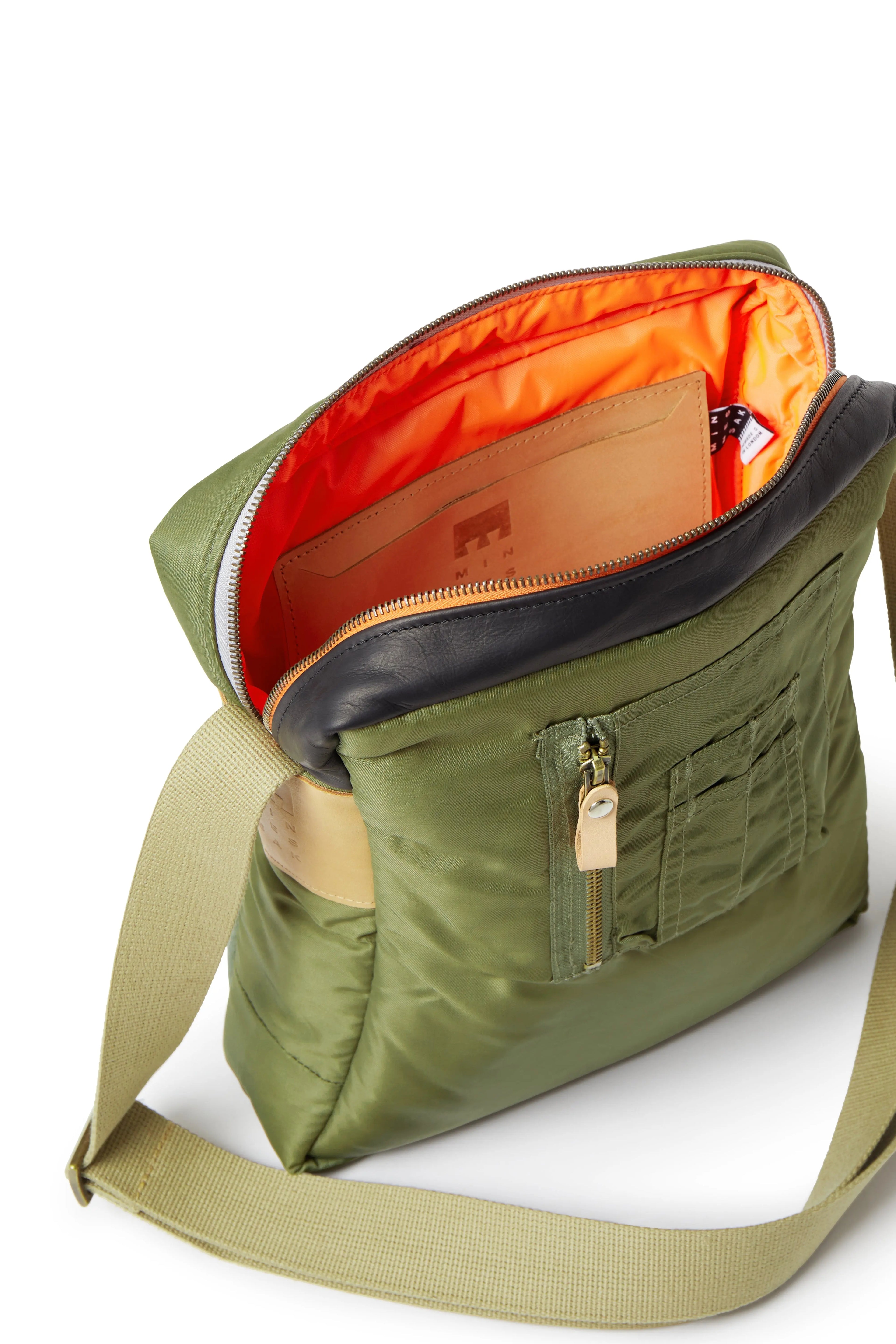 Olive shoulder bag with orange interior on a white background