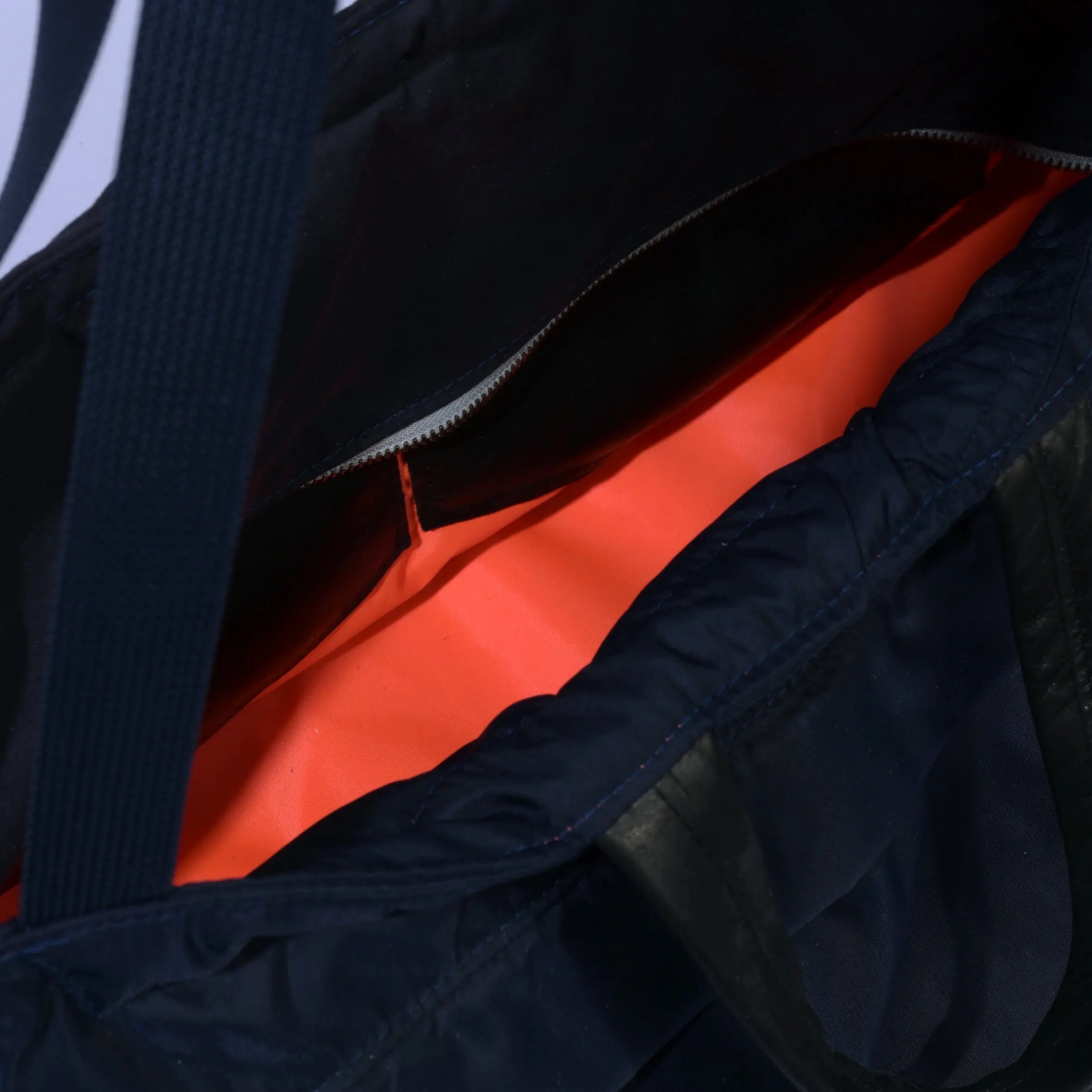 Navy Weekender/Gym bag with strap showing internal detail on white background