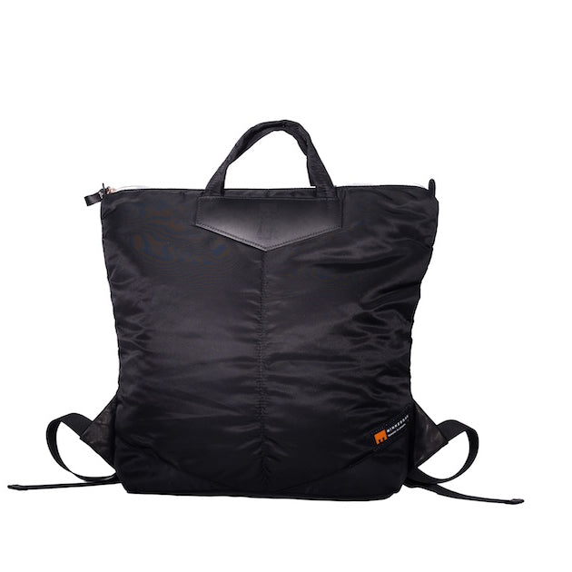 Black Back Up/26 sustainable backpack handmade from repurposed MA-1 flight jacket material with quilted shoulder straps and vintage Italian leather details.