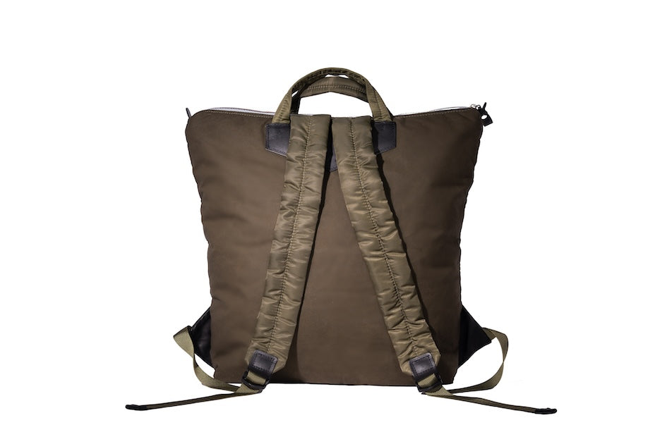 Olive Back Up/26 sustainable backpack handmade from repurposed MA-1 flight jacket material with quilted shoulder straps and vintage Italian leather details.