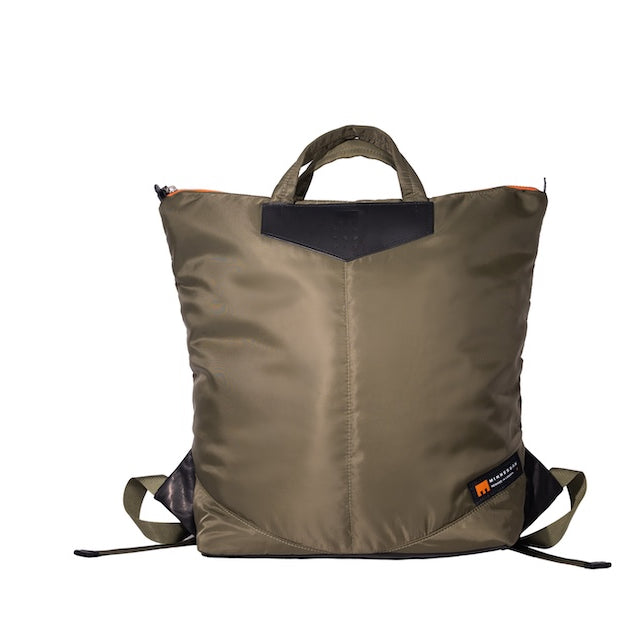 Olive Back Up/26 sustainable backpack handmade from repurposed MA-1 flight jacket material with quilted shoulder straps and leather details.