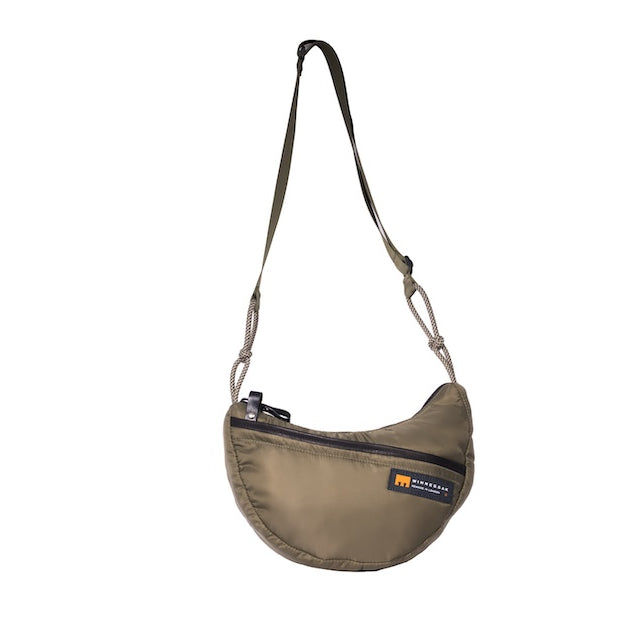 Olive Boat Small sustainable crescent crossbody bag handmade from repurposed MA-1 flight jacket material with adjustable shoulder strap and front zip pocket. Front