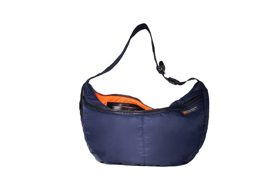 Navy Boat Large, front, sustainable crossbody bag handmade from repurposed MA-1 flight jacket material with adjustable strap, two front zip pockets and internal leather pouch stitched to recycled polyester lining.