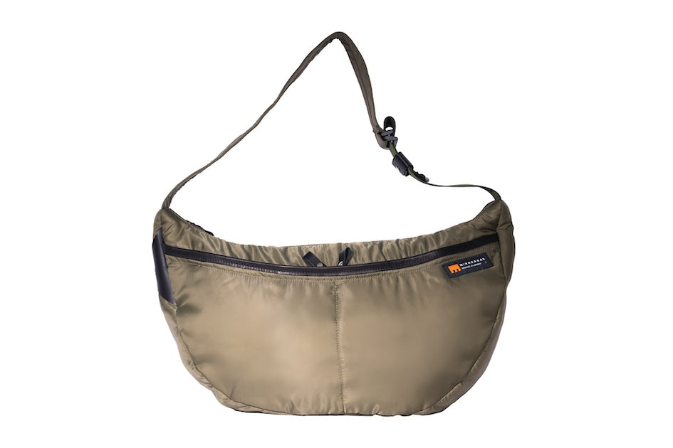Olive Boat Large front sustainable crossbody bag handmade from repurposed MA-1 flight jacket material with adjustable strap and two front zip pockets.
