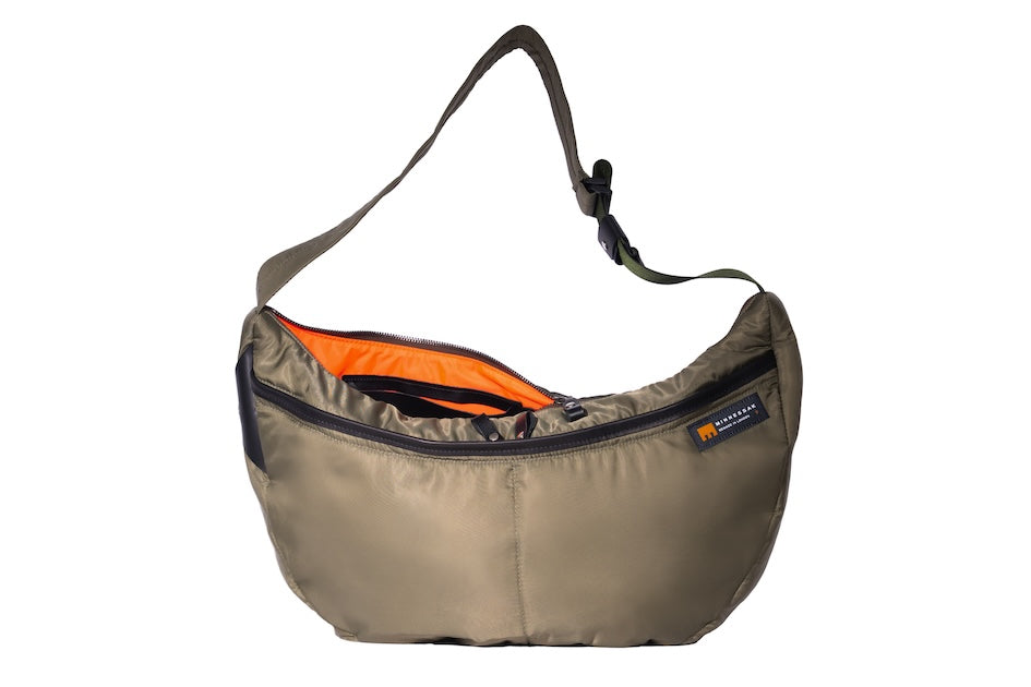 Olive Boat Large front sustainable crossbody bag handmade from repurposed MA-1 flight jacket material with adjustable strap, two front zip pockets and internal zip pocket.
