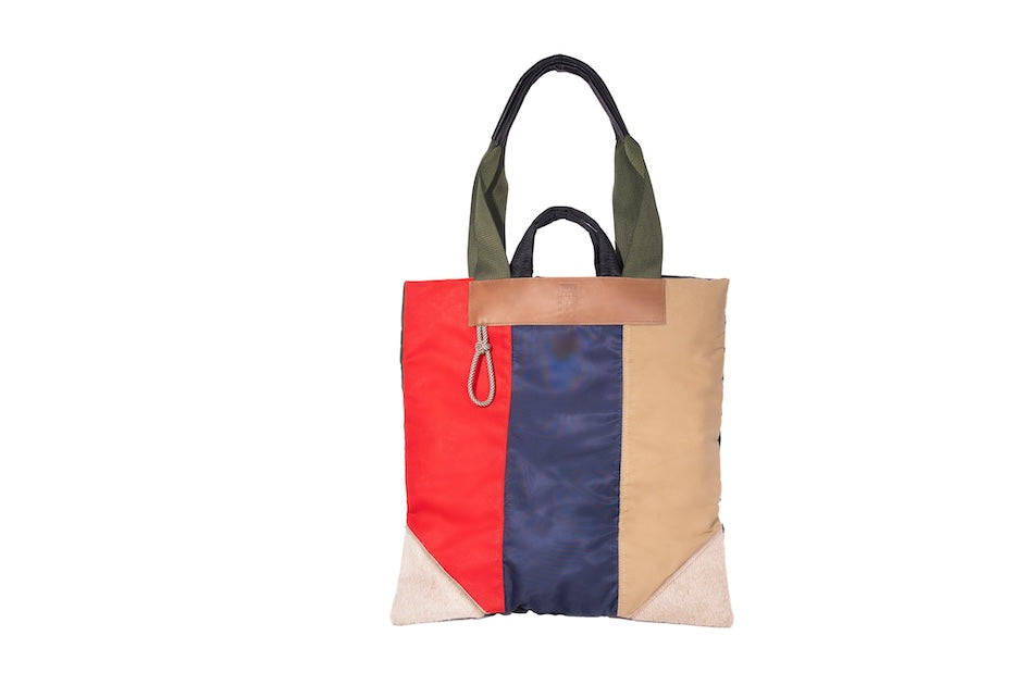 Multicolour Patch Up tote bag handmade from repurposed MA-1 flight jacket and deadstock dry waxed cotton panels with leather details.