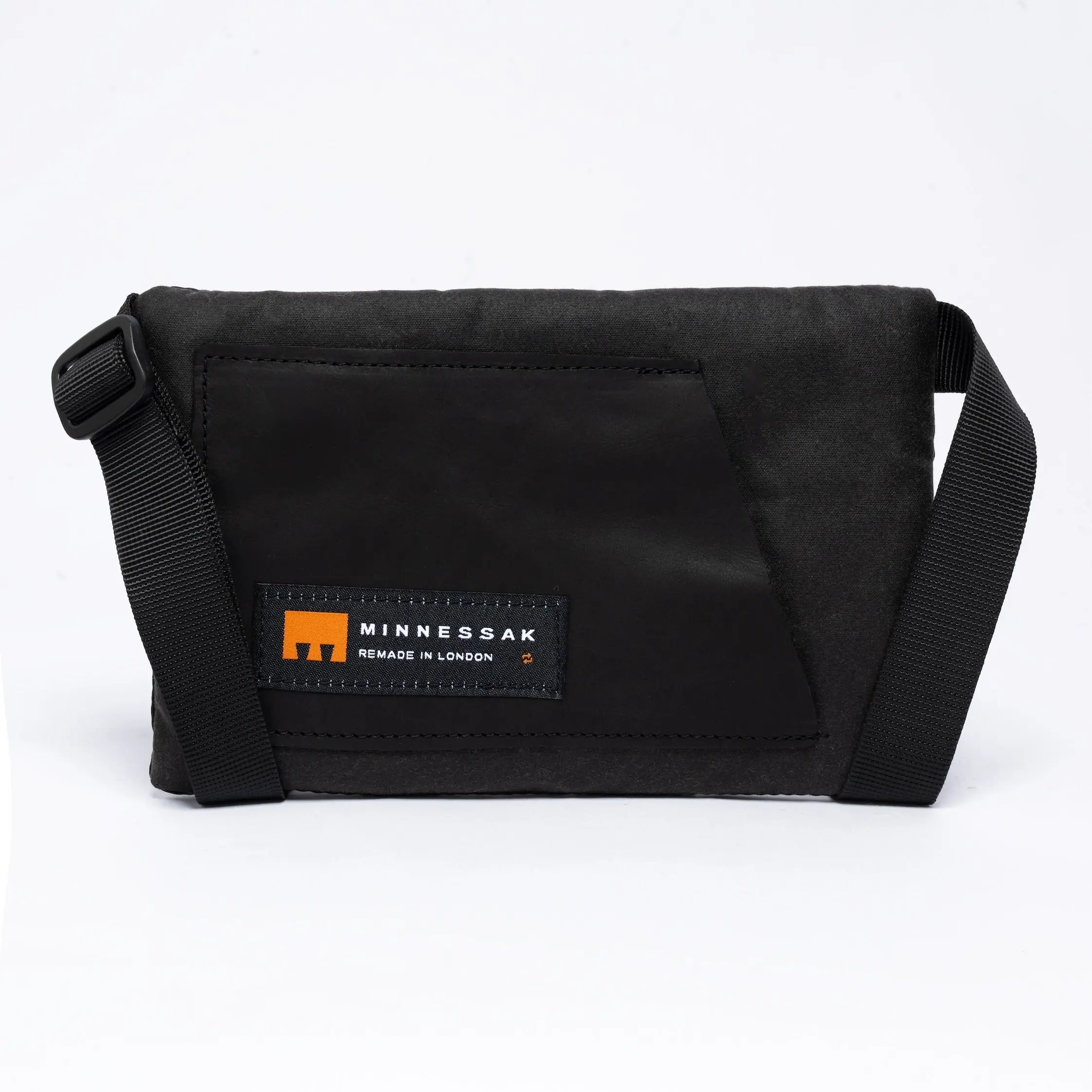 Small cross body bag in black with MInnessak logo on white background