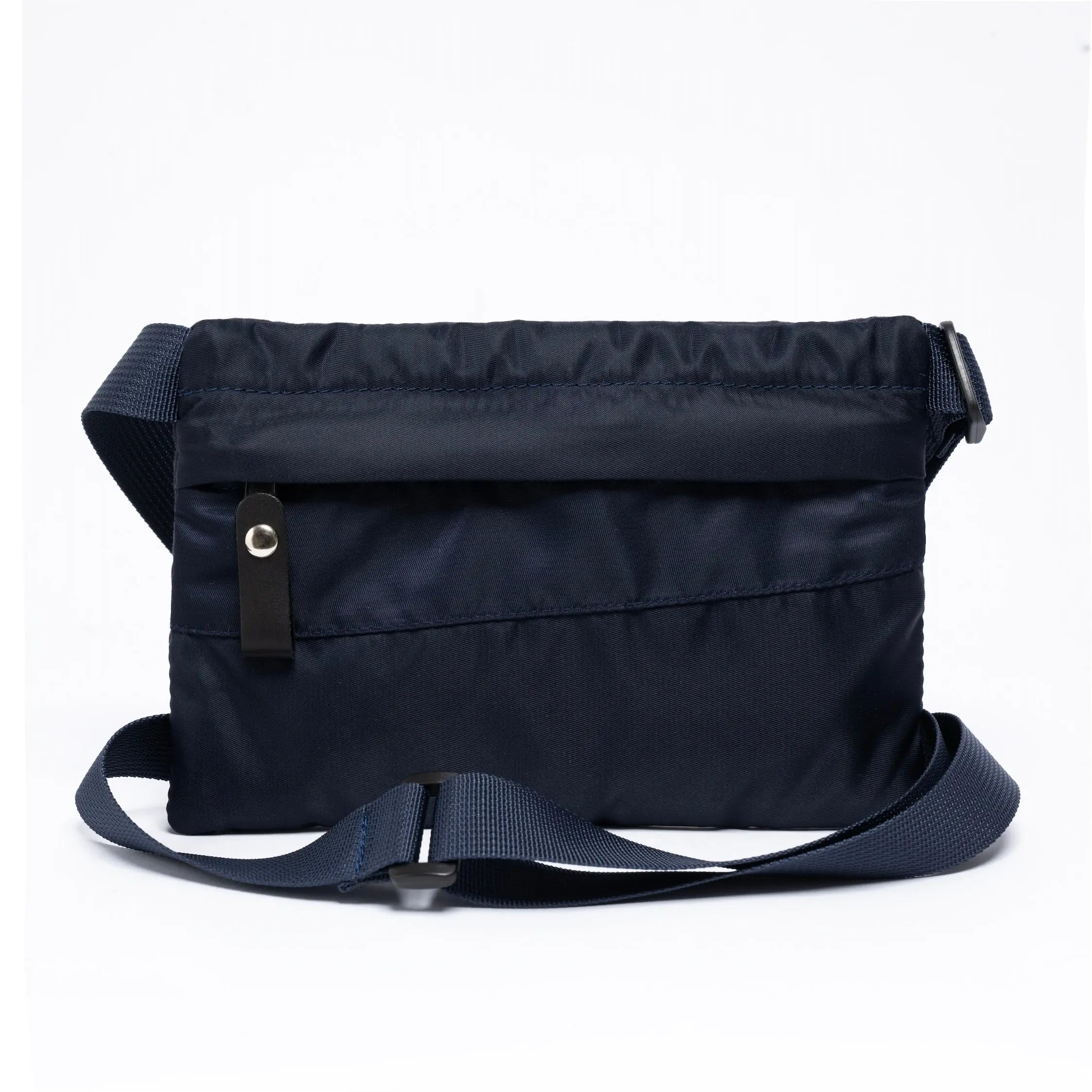 Small cross body bag in navy on a white background