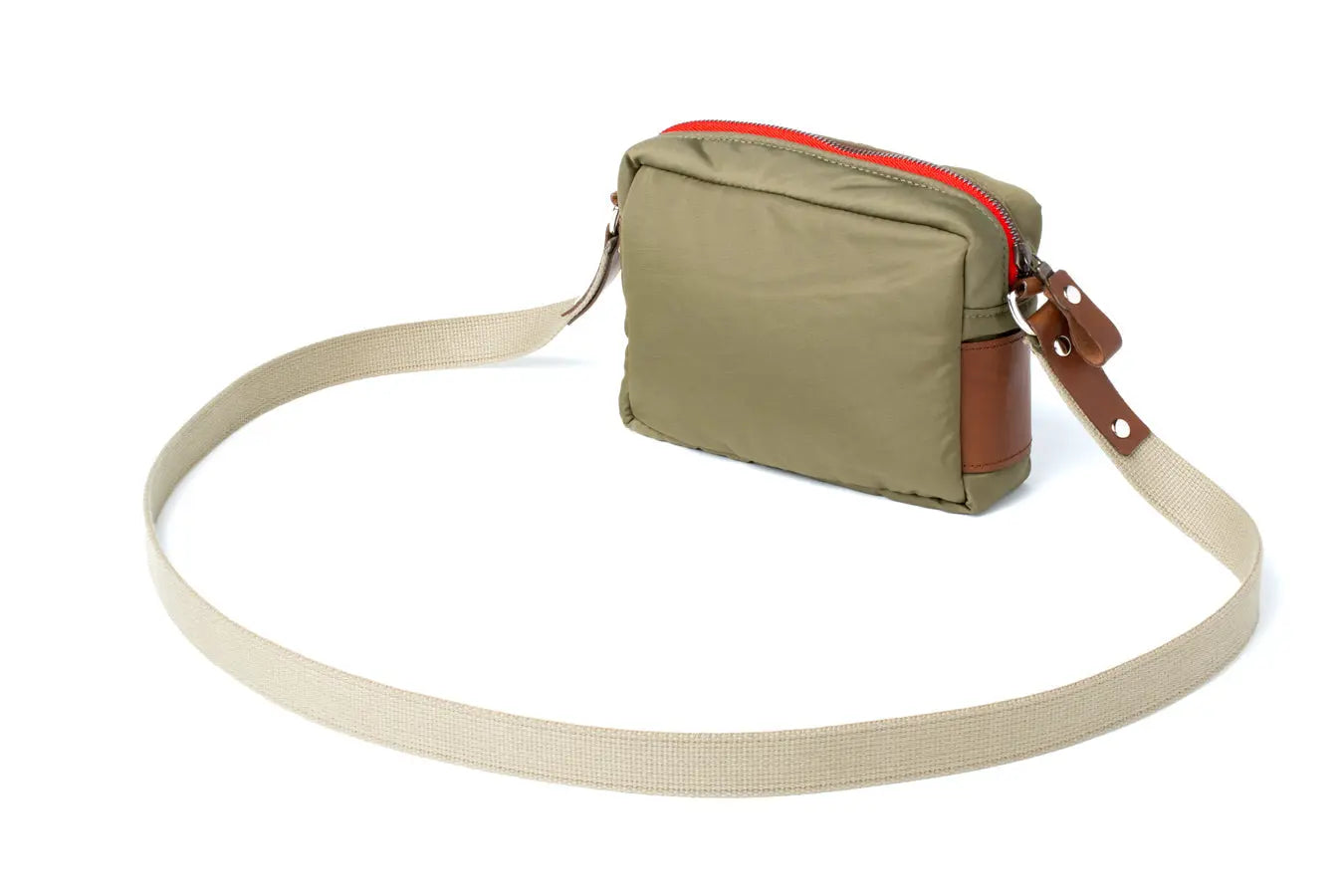 Beige crossbody bag with brown leather accents on a white background