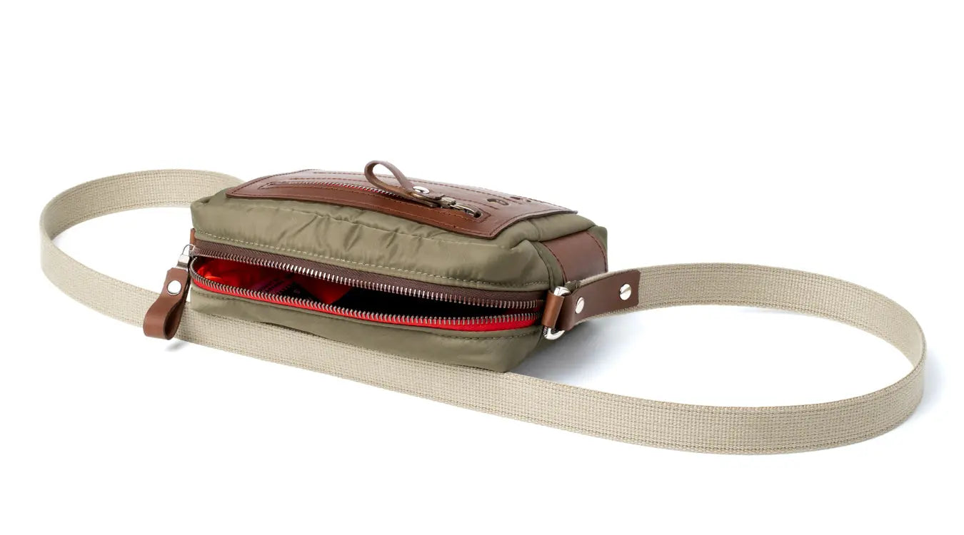 Canvas waist bag with leather accents on a white background