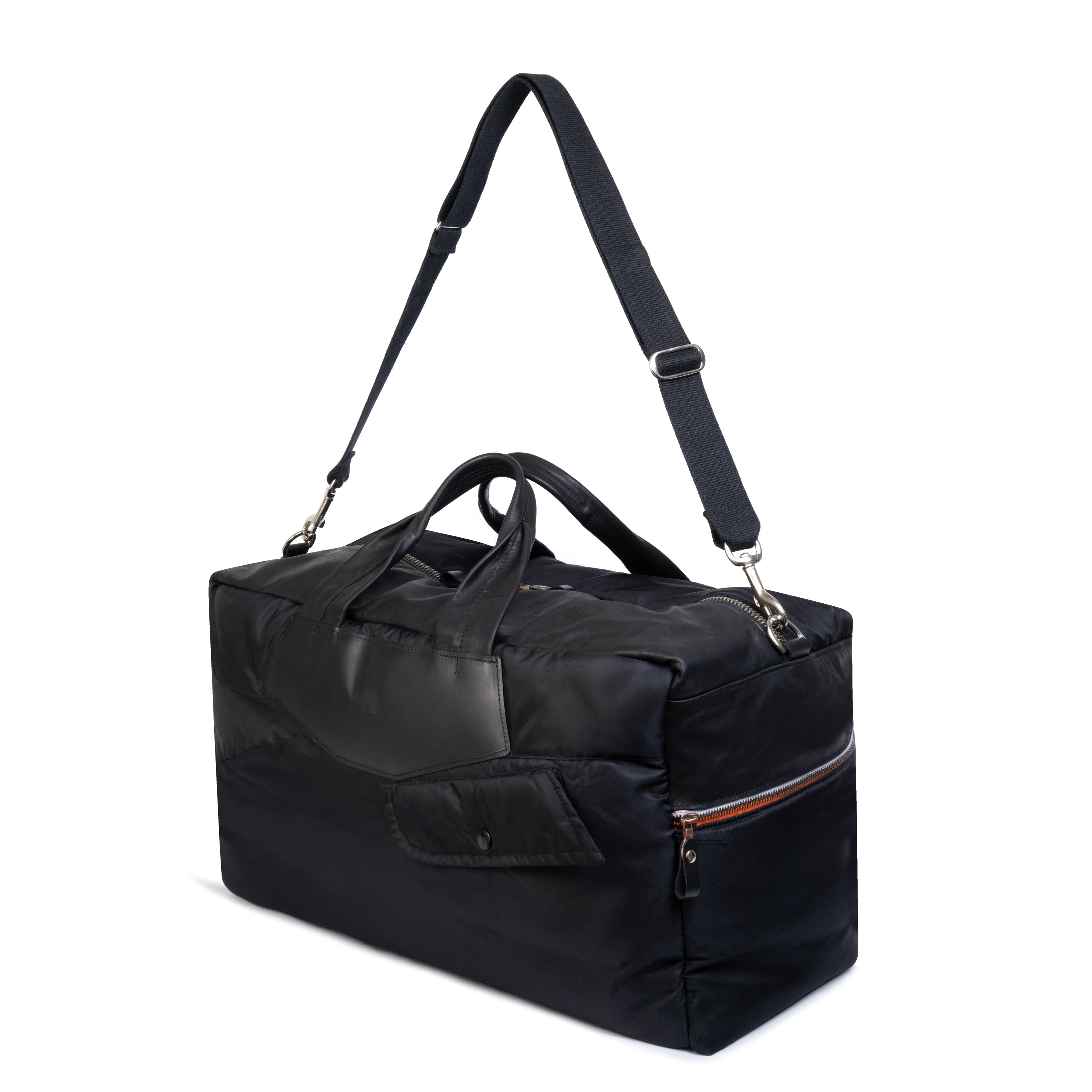 Black duffel bag with a strap on a white background