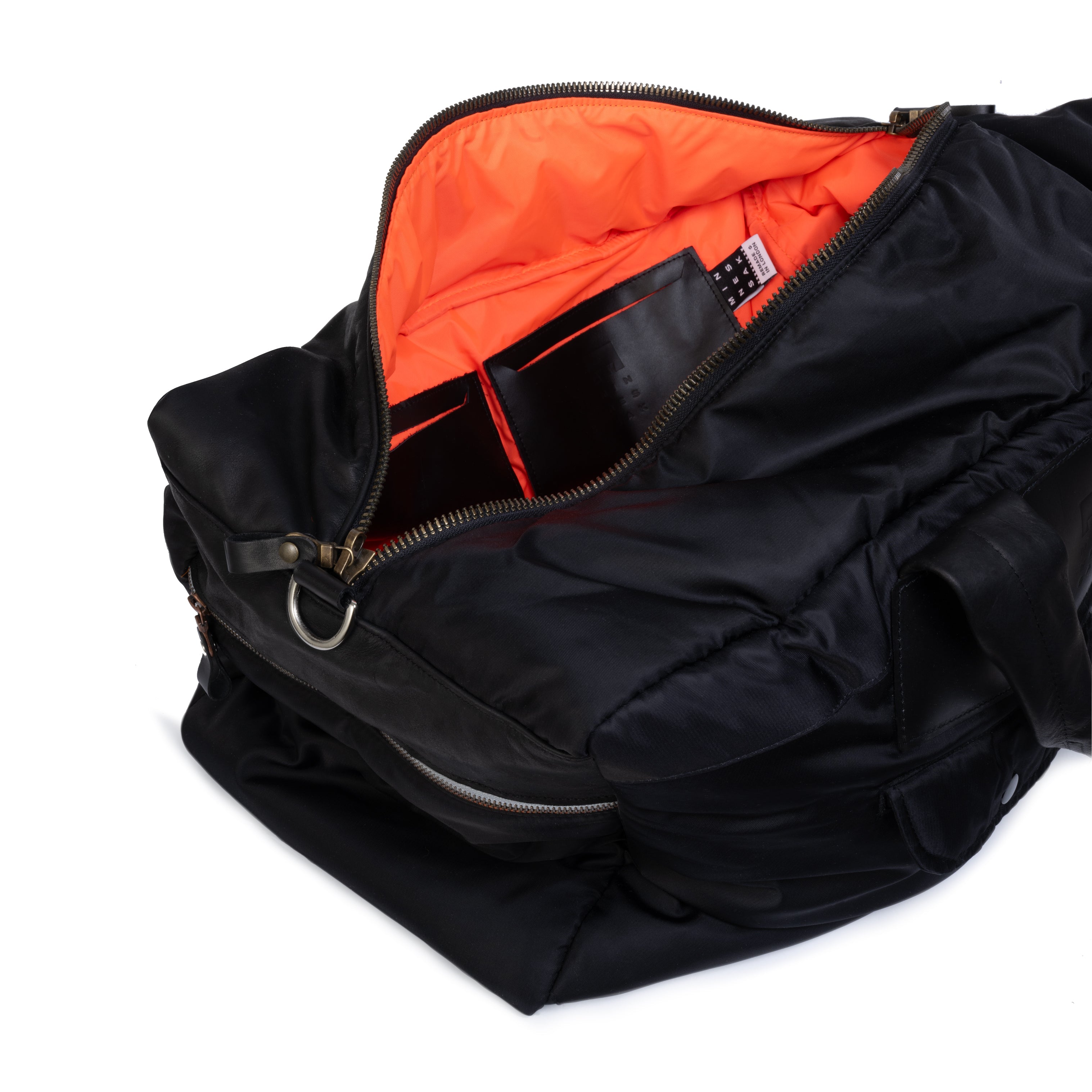 Black buffel bag with orange interior on a white background