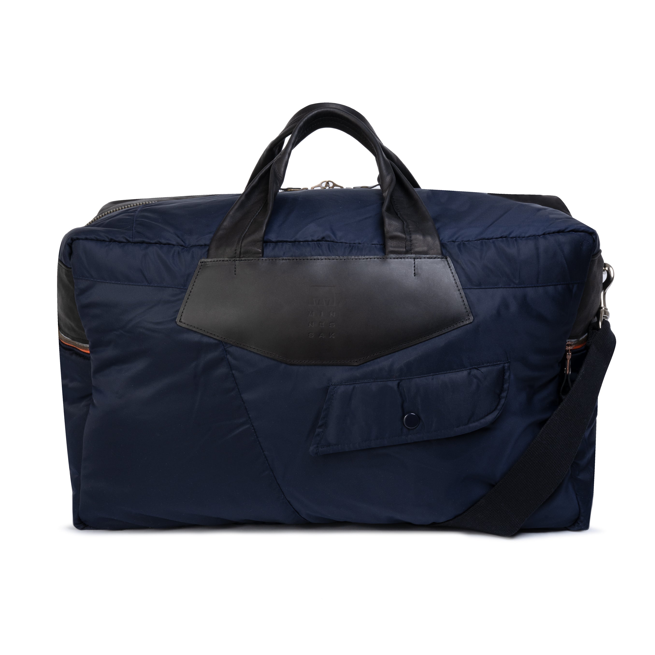 Navy blue duffel bag with black leather accents on a white background