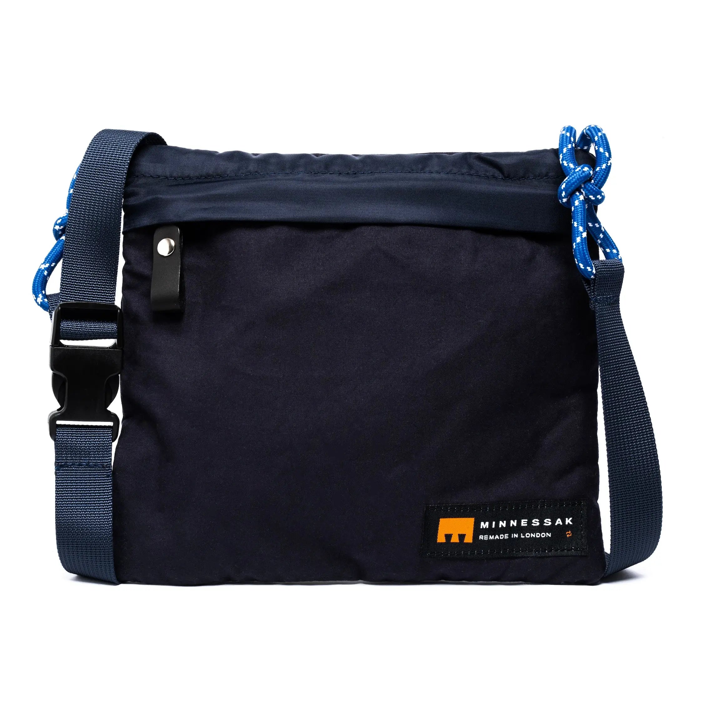 Black bag with blue straps and Minnessak label on a white background