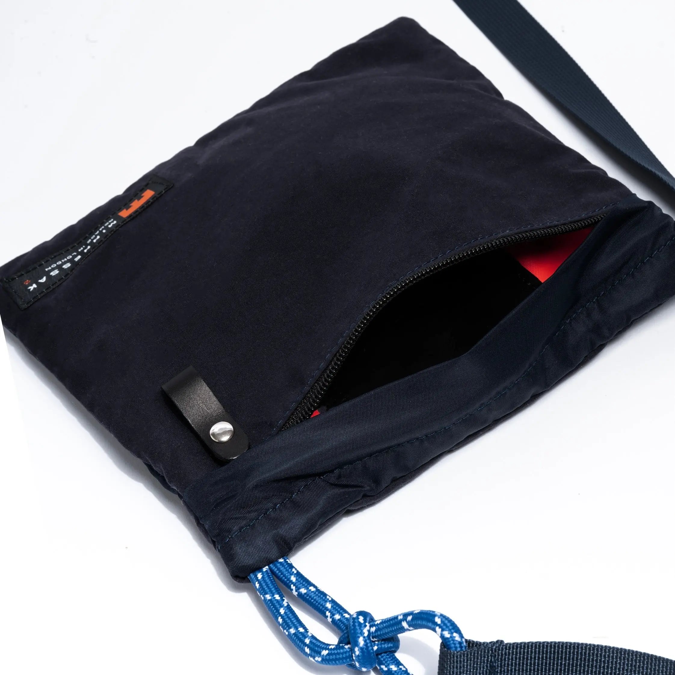 Black bag with a blue rope handle on a white background