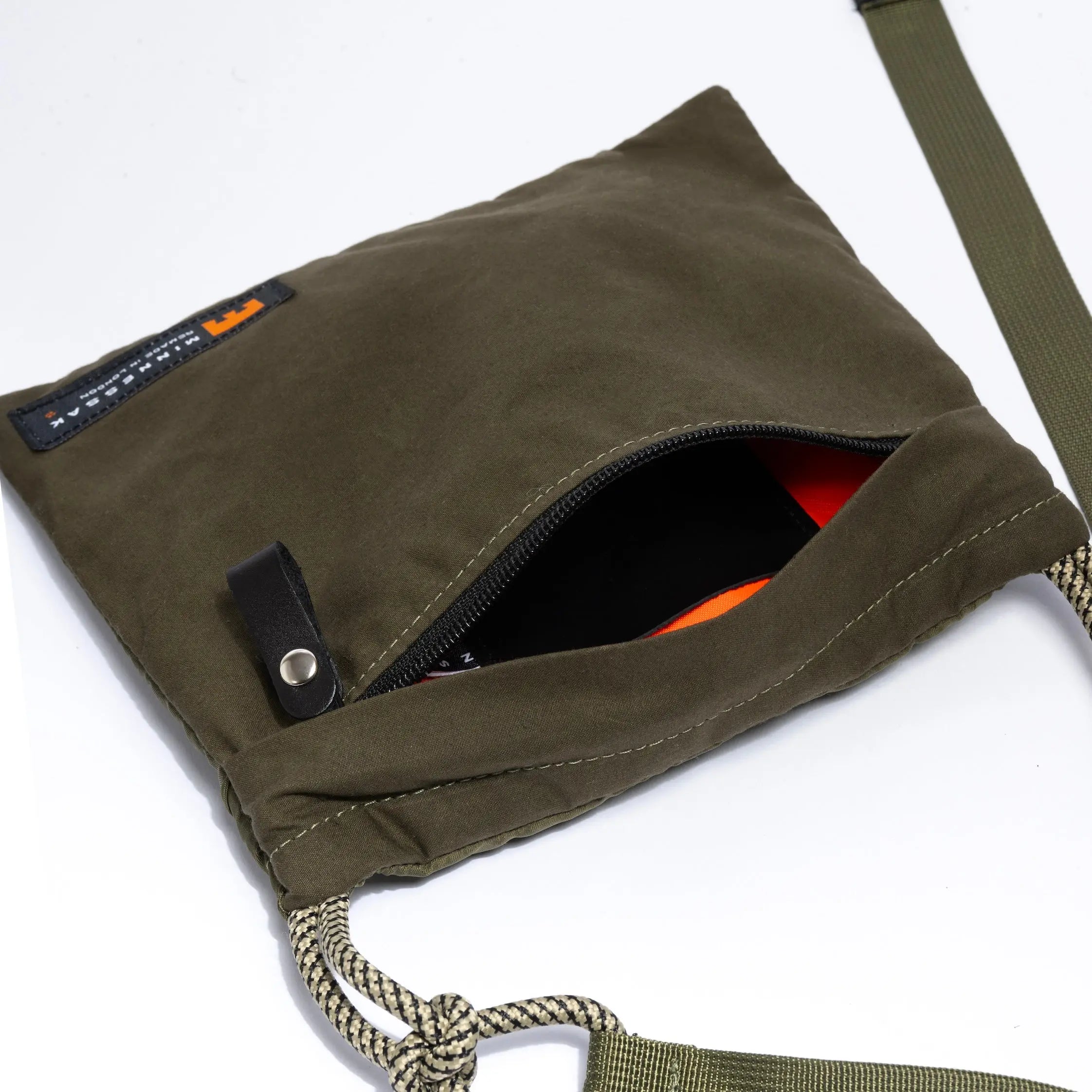 Olive canvas bag with a zipper on a white background