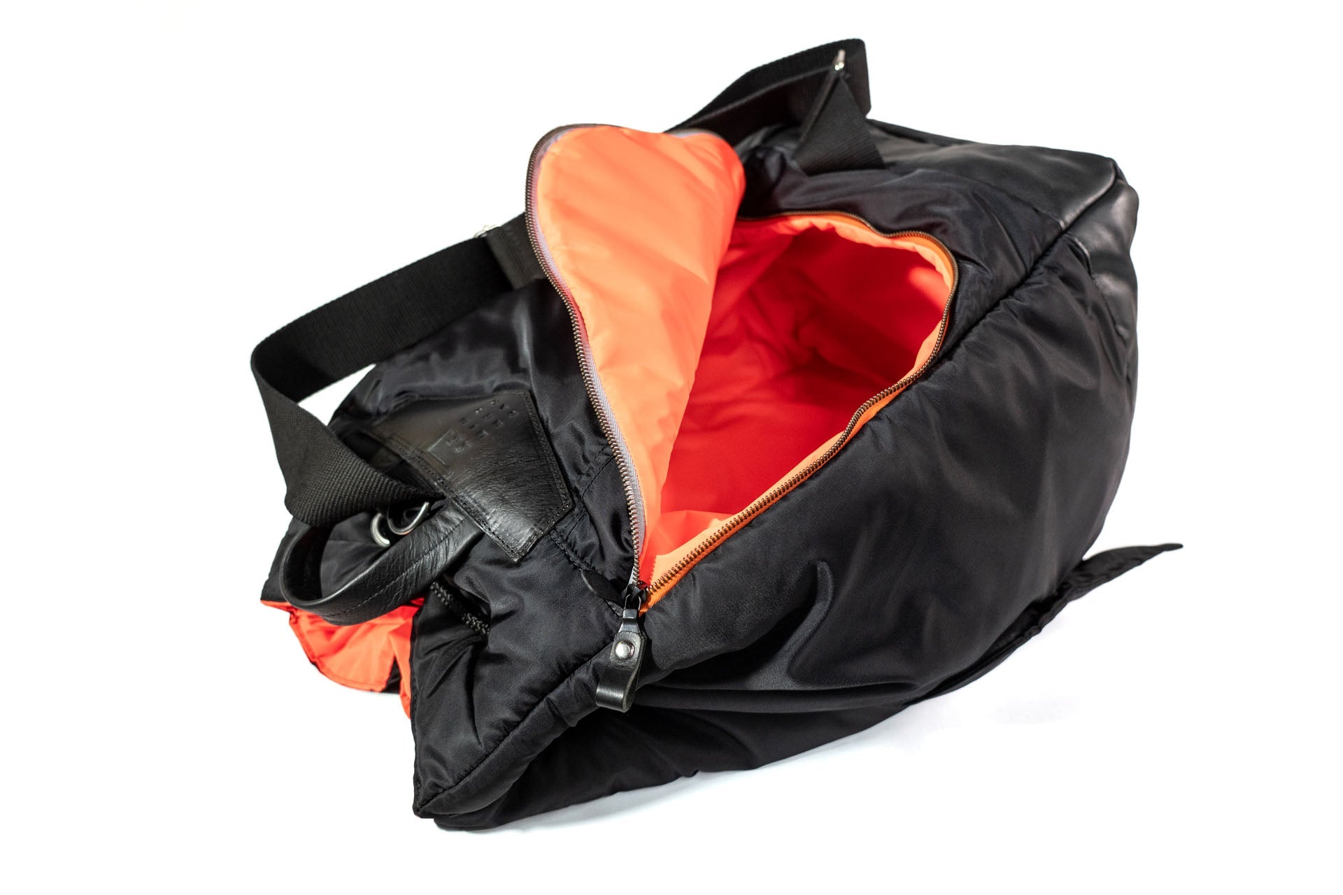 Black bag with orange interior on a white background
