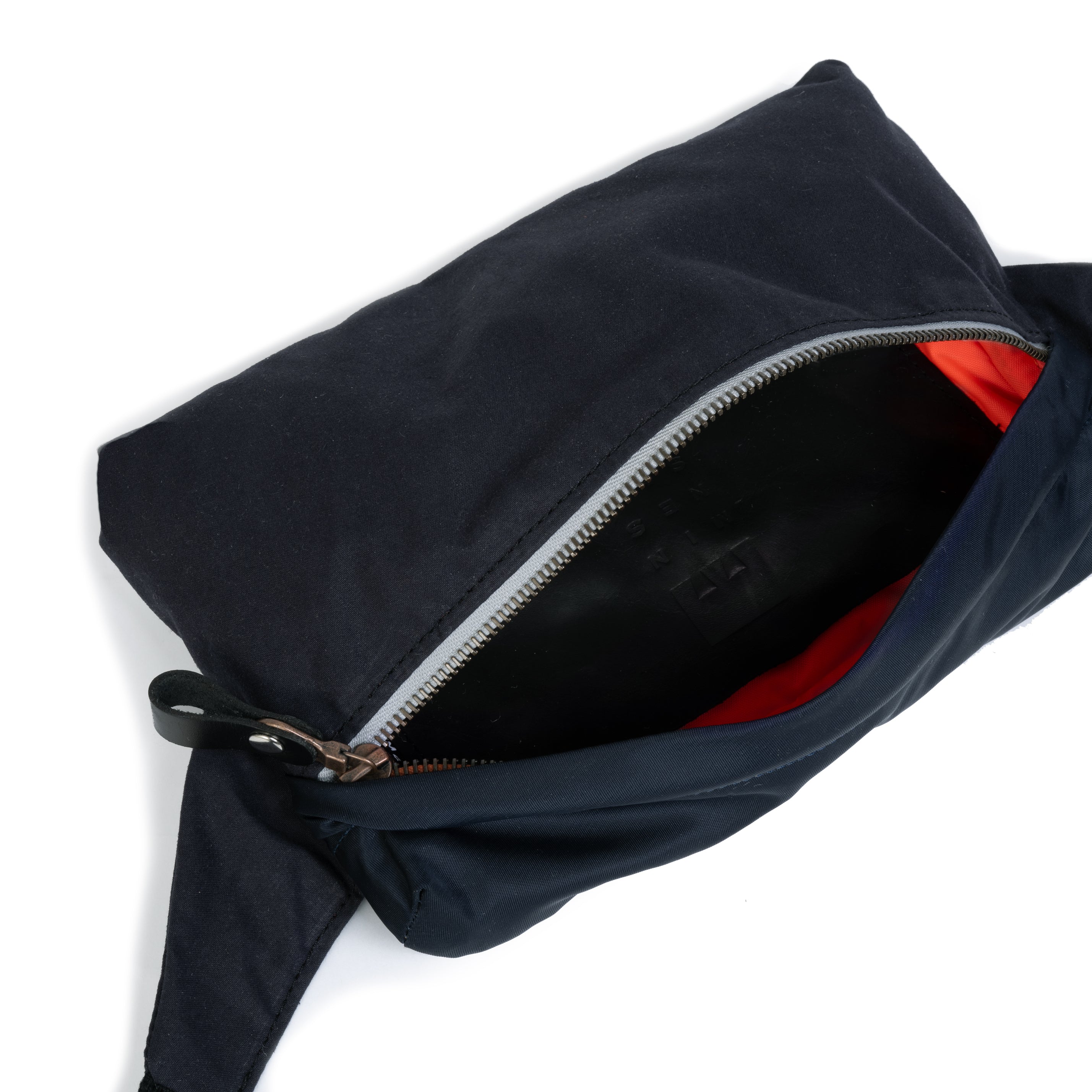Black bag with a zipper on a white background showing the interior part.