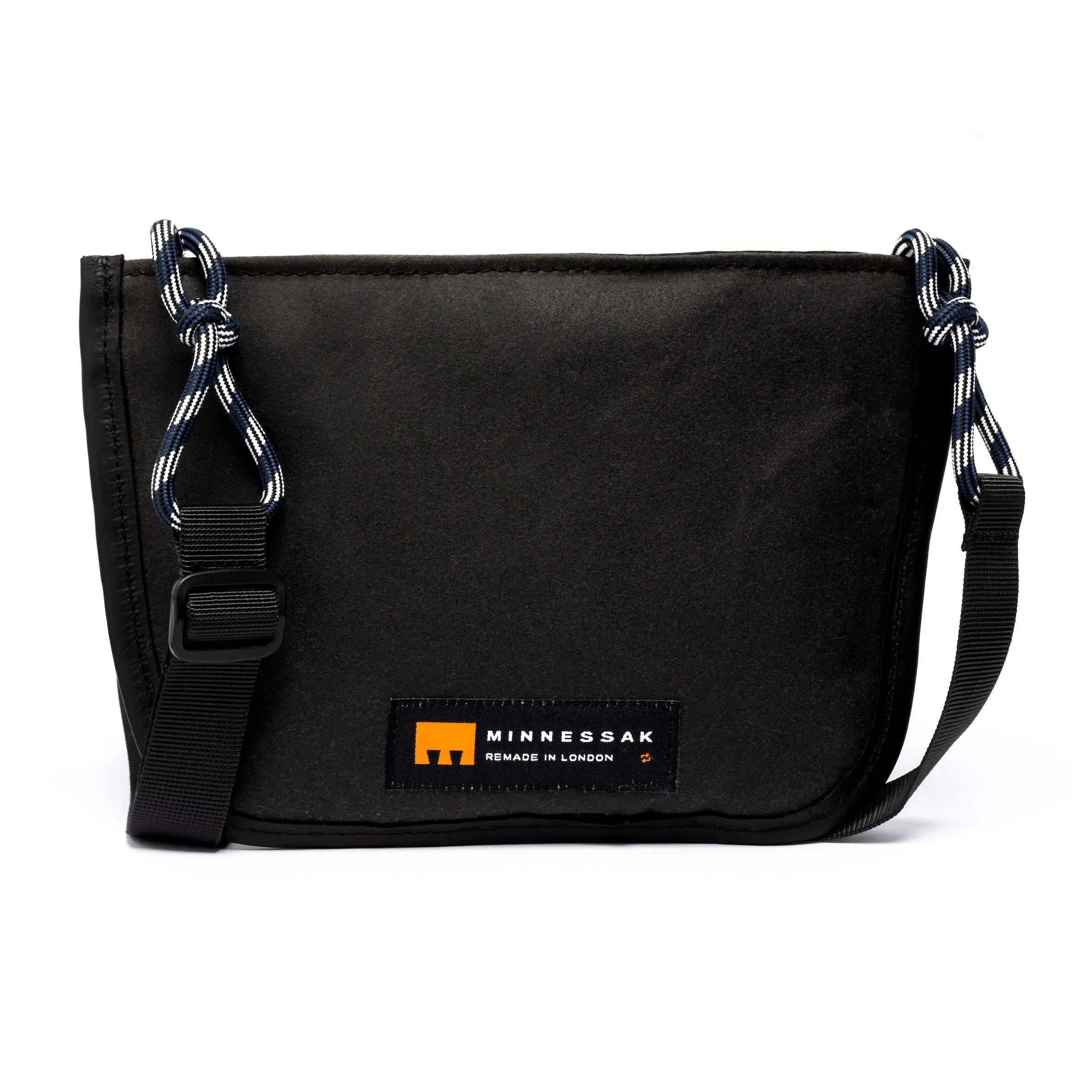 Black shoulder/cross body bag with strap detail and MInnessak logo on white background