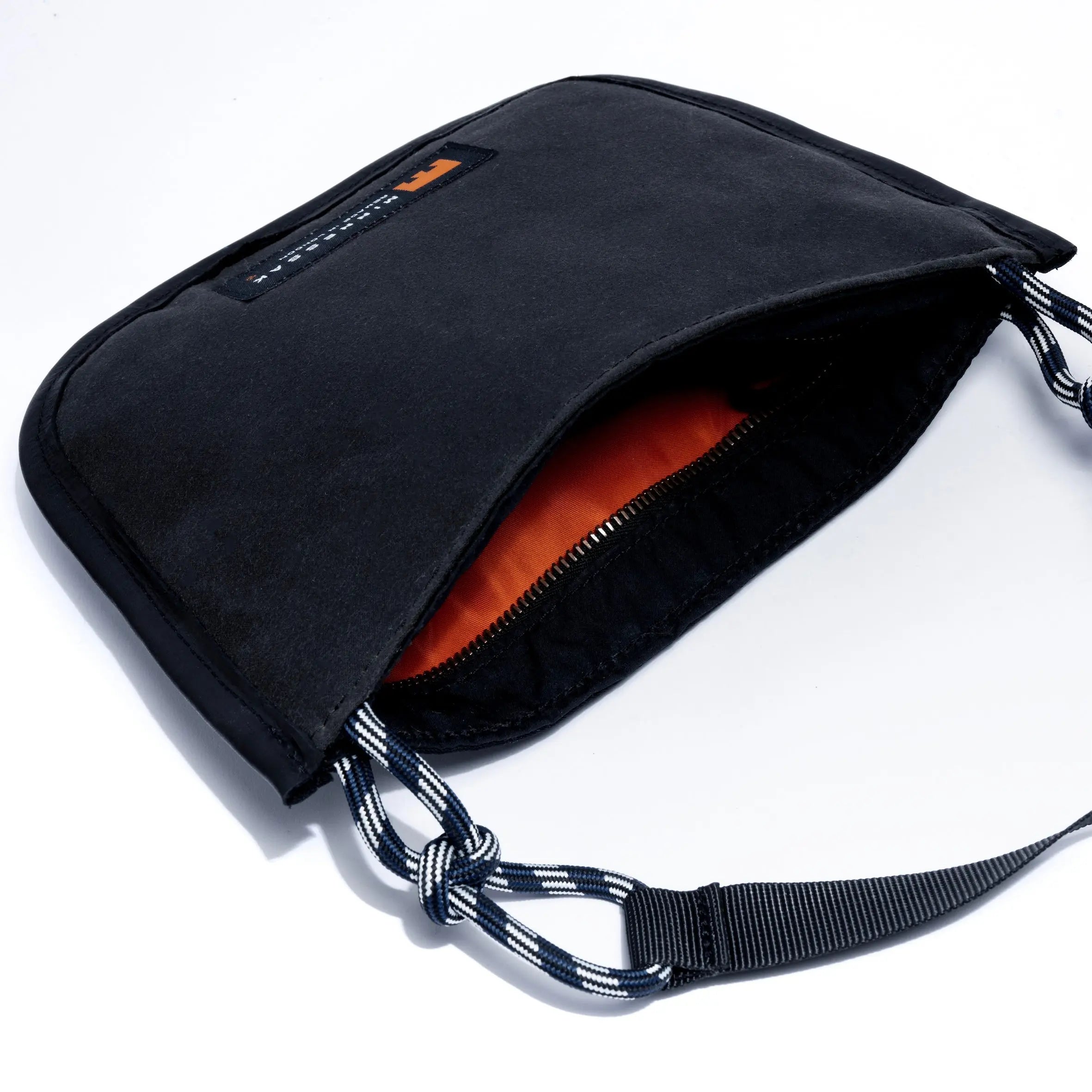 Black shoulder/cross body bag with strap and internal detail on white background