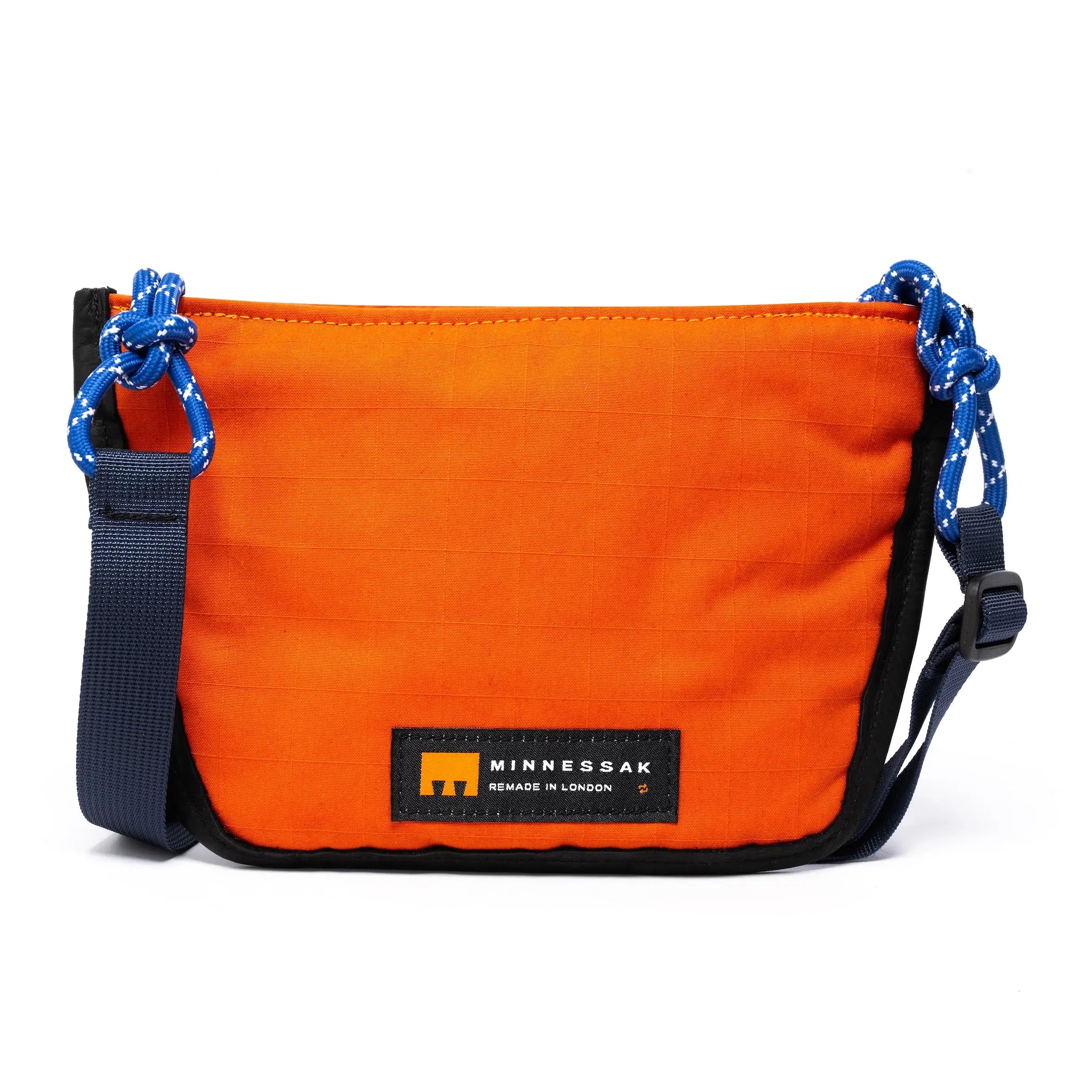 Navy & orange shoulder/cross body bag withe strap details and Minnessak logo on white background