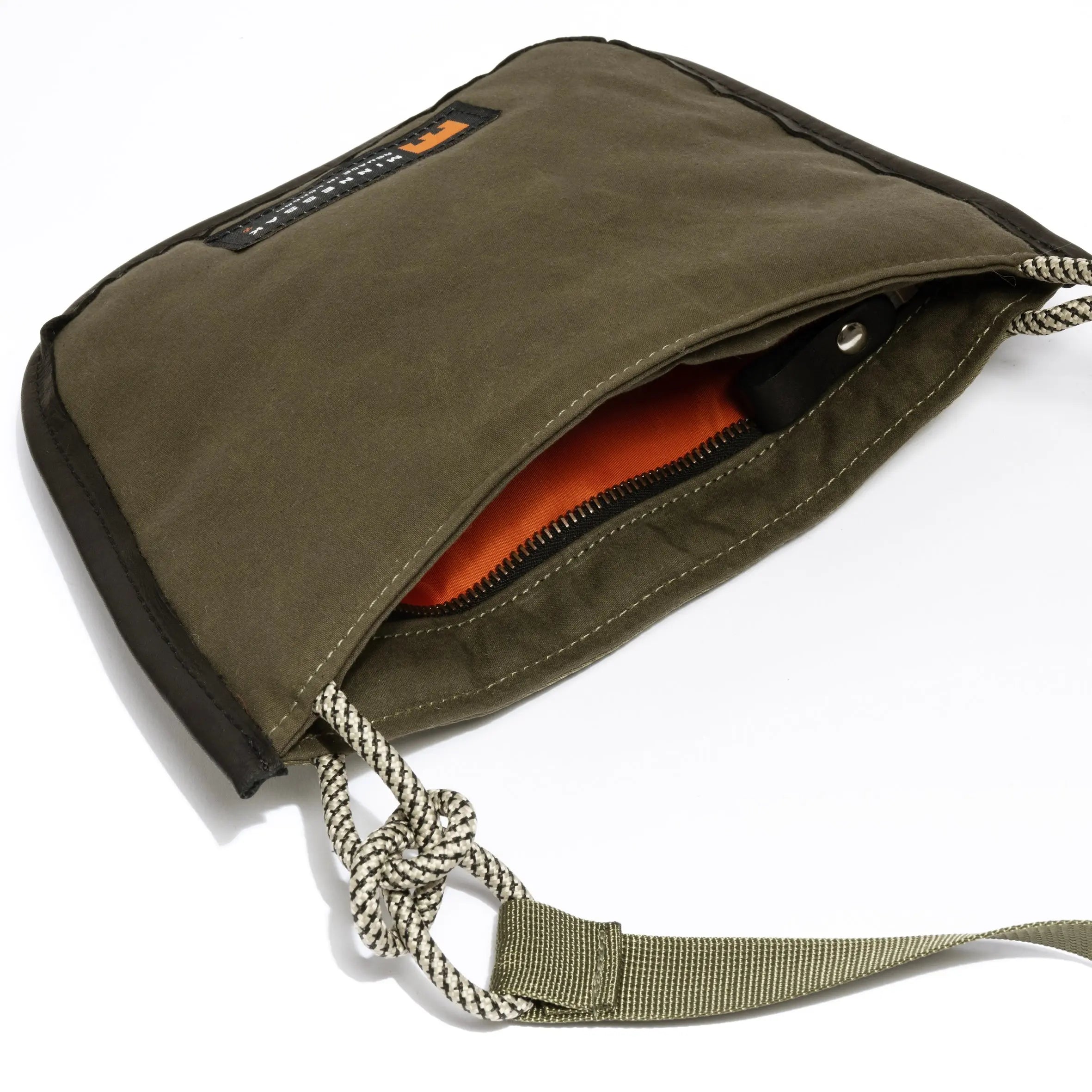 Olive shoulder/cross body bag showing internal orange detail on white background