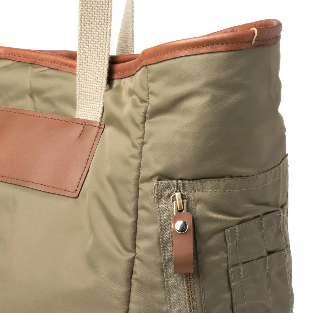 Close-up of an Olive bag with brown accents on a white background